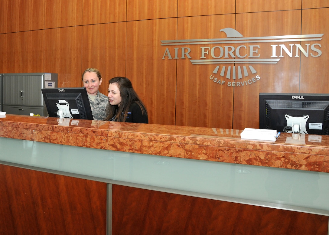 Staff Sgt. Adrianne Johnson, 104th Services Flight, Barnes Air National Guard Base, Westfield, Mass., receives training from Alley Carollo, Guest Services Representative, May 7, 2015, on the front desk computer system, Air Force Inn, Kaiserslautern Military Community Center, Ramstein Air Base, Germany. Johnson trained at the KMCC Air Force Inn May 5-7 in the areas of housekeeping, inspecting rooms, accounting, reservations, and supply, allowing her to sign off on requirements for her services position. (U.S. Air National Guard photo by Tech. Sgt. Melanie J. Casineau/ Released)