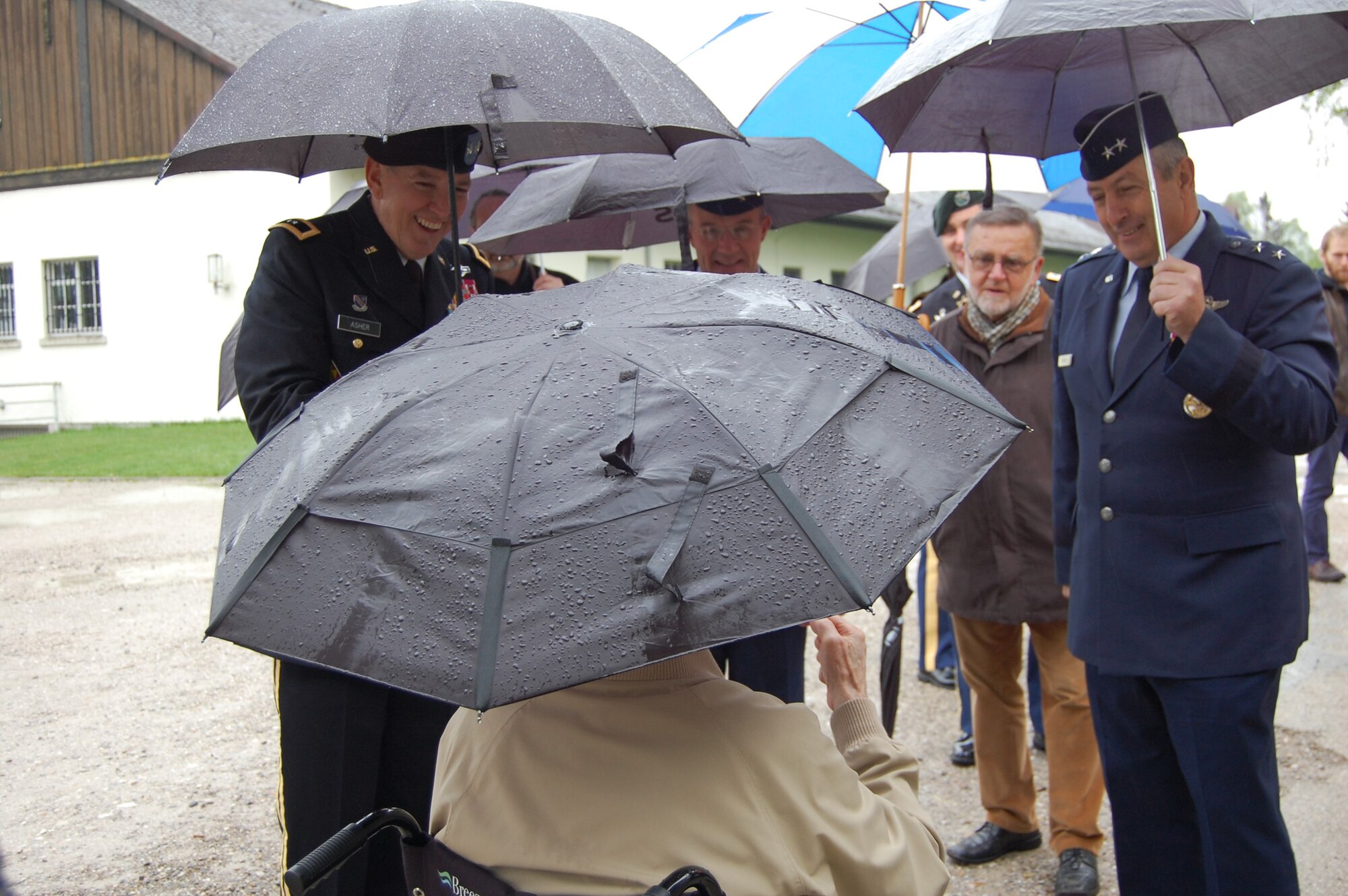 Maj. Gen. Robbie Asher, the Adjutant General of Oklahoma, Brig. Gen. Jerome Limoge, the Assistant Adjutant General of Colorado for Air, and Maj. Gen. H. Michael Edwards, the Adjutant General of Colorado, listen to stories from one of the liberators of Dachau Concentration Camp. Members of the Colorado and Oklahoma National Guard participated in various ceremonies May 1-3, 2015, commemorating the 70th anniversary of the liberation of the concentration camp, Dachau. The 157th Infantry Regiment, one of the units that liberated the camp on April 29, 1945, initially mustered from the state of Colorado. The regiment was a subordinate unit to the 45th Infantry Division, initially formed in Oklahoma. (Air National Guard photo by Capt. Kinder Blacke)