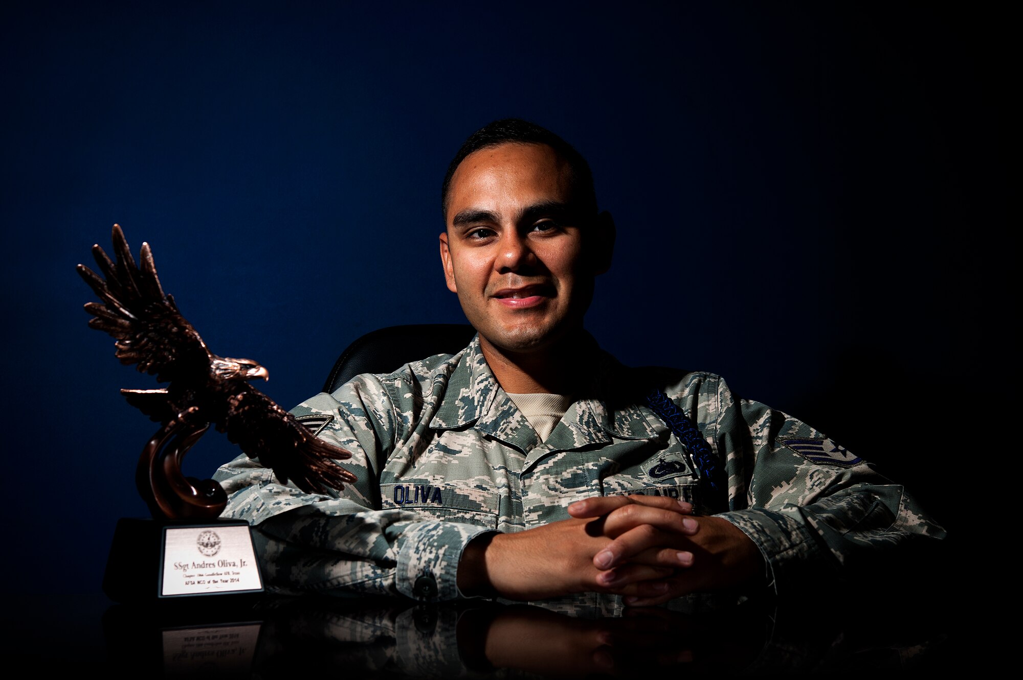 U.S. Air Force Tech. Sgt. Andres N. Oliva Jr., 316th Training Squadron military training leader, poses with the Air Force Sergeant Association NCO of the Year award at the 316th TRS dormitories on Goodfellow Air Force Base, Texas, May 6, 2015. Oliva won the award for the division four category, a chapter spanning from Texas to Mississippi. (U.S. Air Force photo by Senior Airman Scott Jackson/Released)
