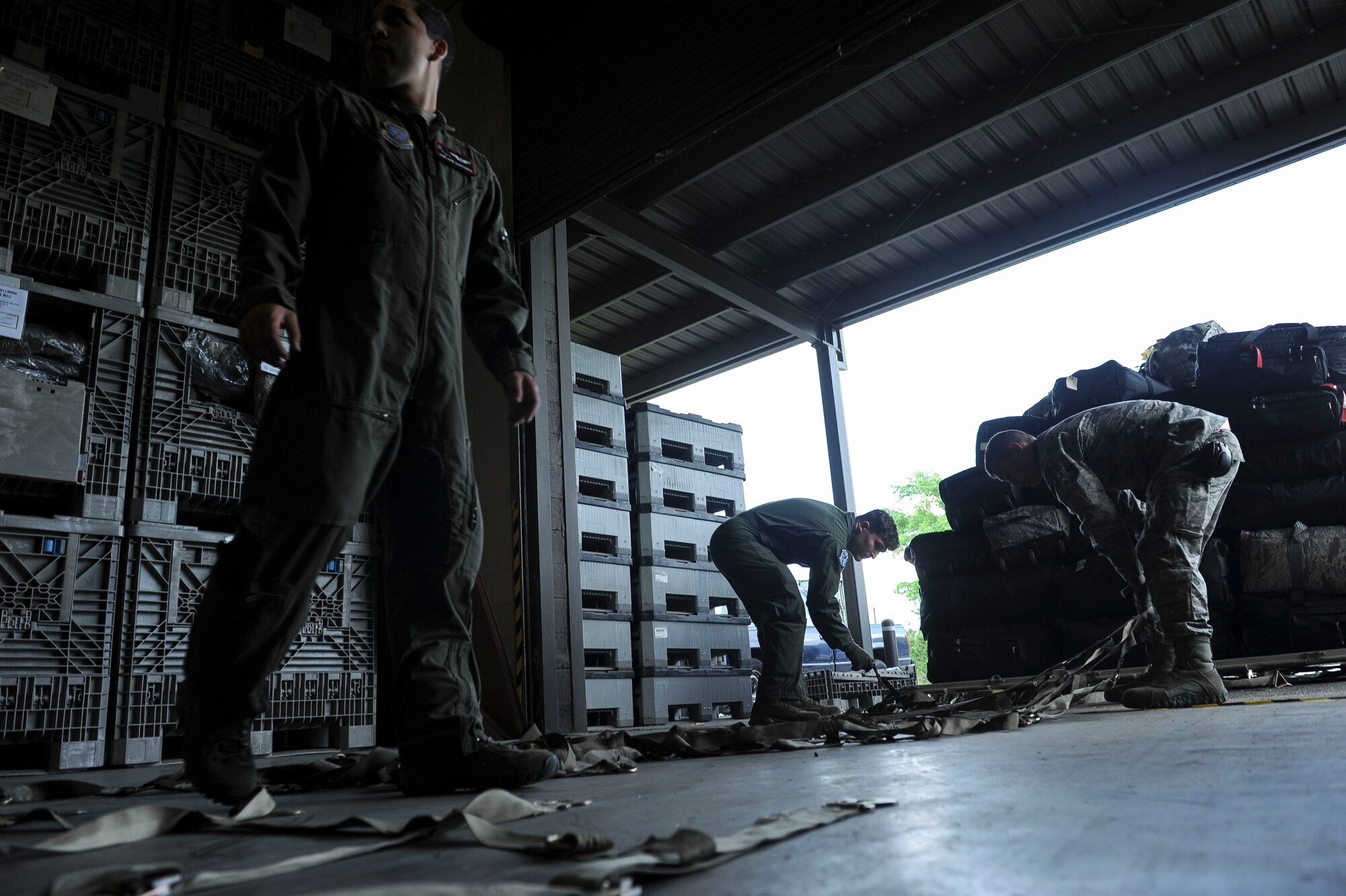 Loadmasters from the 41st Airlift Squadron and the 61st Airlift Squadron work together to secure the luggage of Team Little Rock members, who are leaving for deployment May 4, 2015, at Little Rock Air Force Base, Ark. Team Little Rock deployed approximately 100 Airmen to support contingency operations in Southwest Asia. (U.S. Air Force photo/Airman 1st Class Cliffton Dolezal)