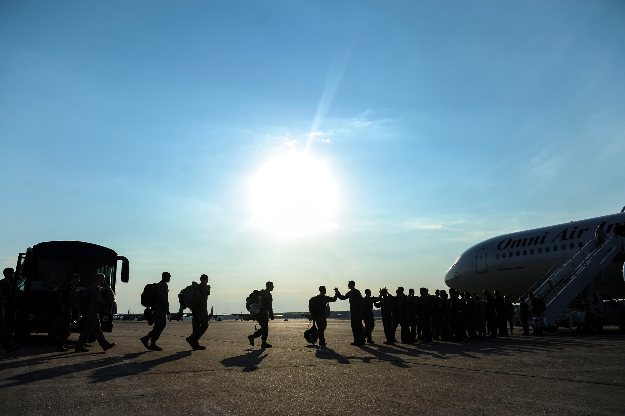 Team Little Rock members are greeted by base leadership as they board their plane for deployment May 4, 2015, at Little Rock Air Force Base, Ark. These Airmen specialize in enabling combat airlift while deployed downrange. (U.S. Air Force photo/Airman 1st Class Cliffton Dolezal)