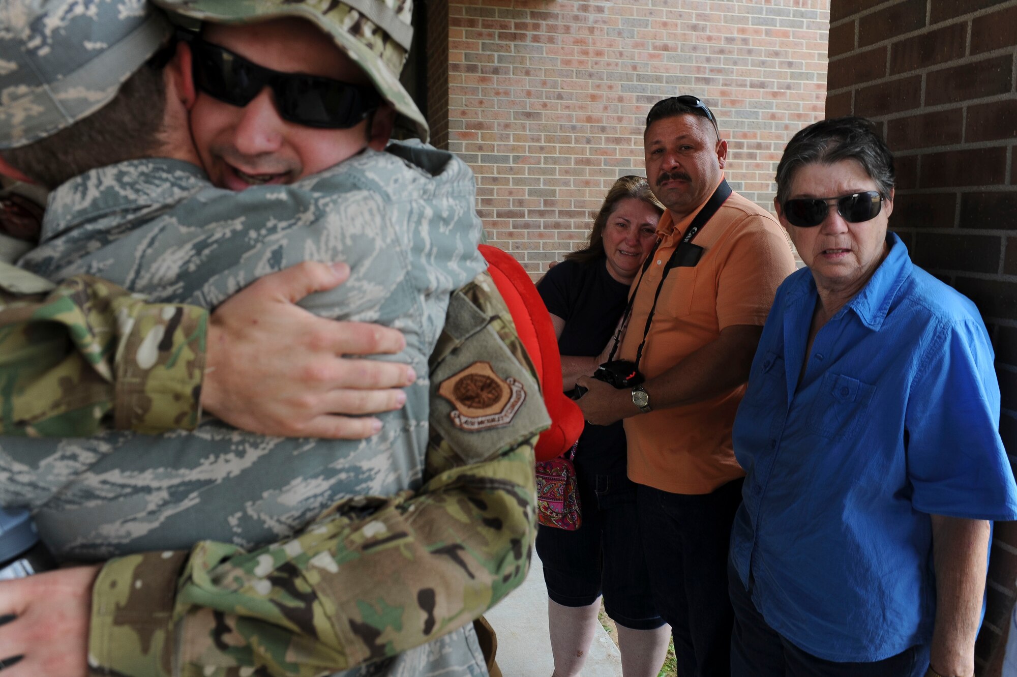 Senior Airman Sean Zeringue, a 61st Airlift Squadron loadmaster, says goodbye to friends and family before leaving for deployment May 4, 2015, at Little Rock Air Force Base, Ark. Mixed emotions of high-fives and well wishes shared with tears and kisses flooded the 61st AS before it was time to say “goodbye” to their loved ones and head downrange. (U.S. Air Force photo/Airman 1st Class Cliffton Dolezal)