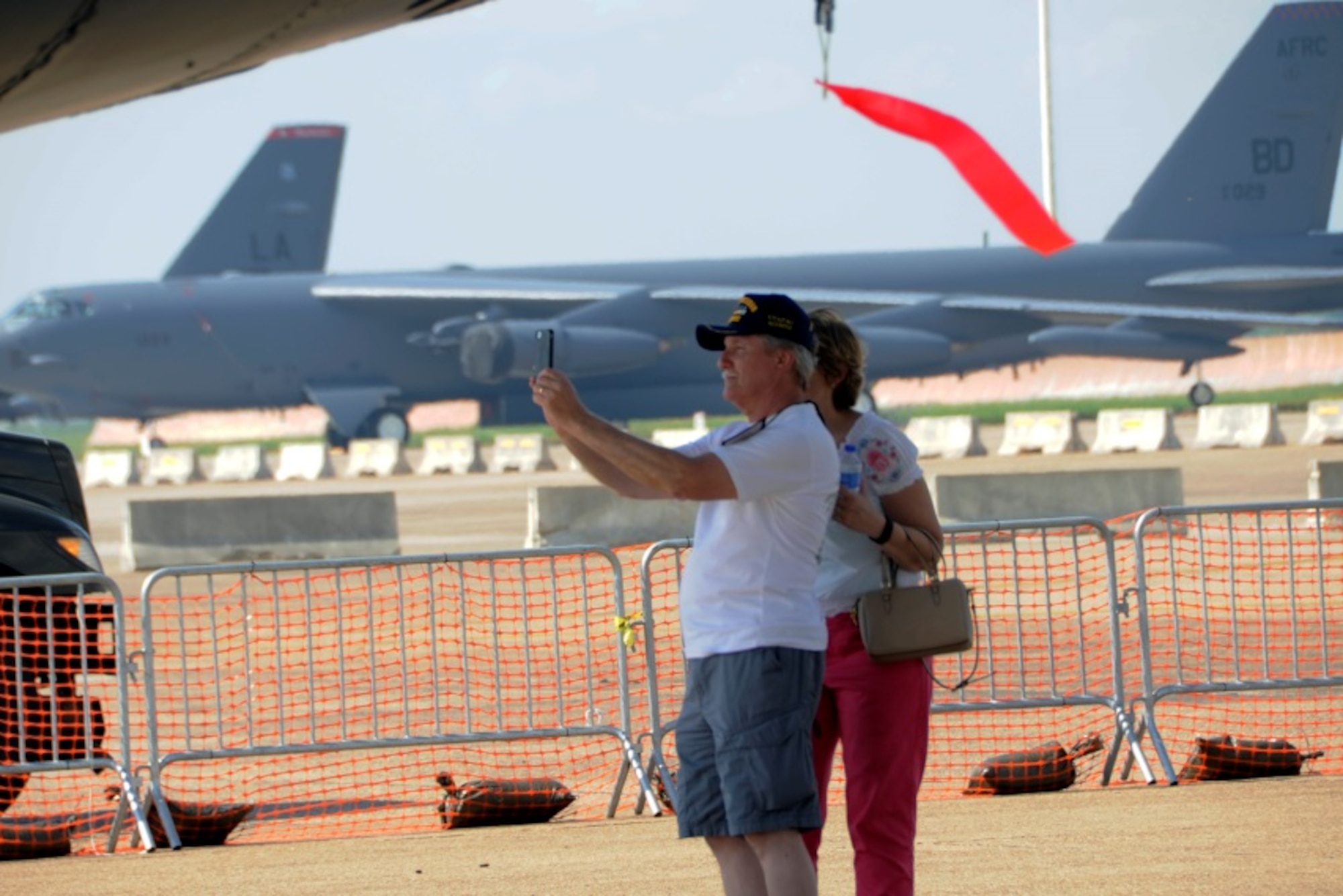 A Vietnam Veteran and his wife take a photograph of an engine of the B-52 named the Lone Star Lady II at Barksdale Air Force Base, La., on May 1, 2015. The 307th Bomb Wing alumni were given a VIP tour prior to the Defenders of Liberty Air Show where the static aircraft was dedicated to the men and women who served during Vietnam War. (U.S. Air Force photo by Master Sgt. Laura Siebert/Released) 