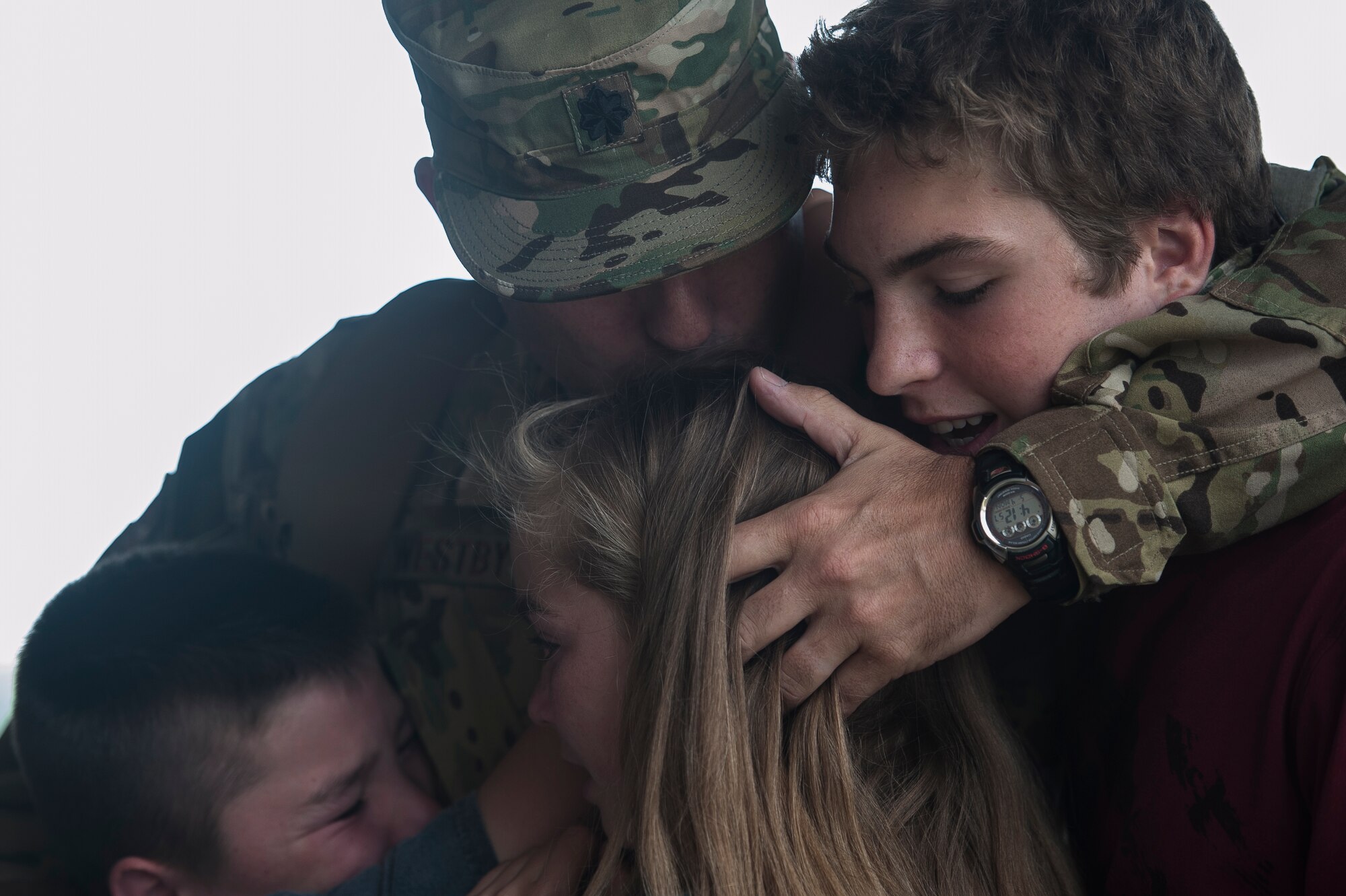 Lt. Col. Eric Westby, 61st Airlift Squadron commander, hugs his children one last time before deploying May 4, 2015, at Little Rock Air Force Base, Ark. Westby and more than 70 Airmen headed downrange to support combat airlift missions. (U.S. Air Force photo by Senior Airman Kaylee Clark)