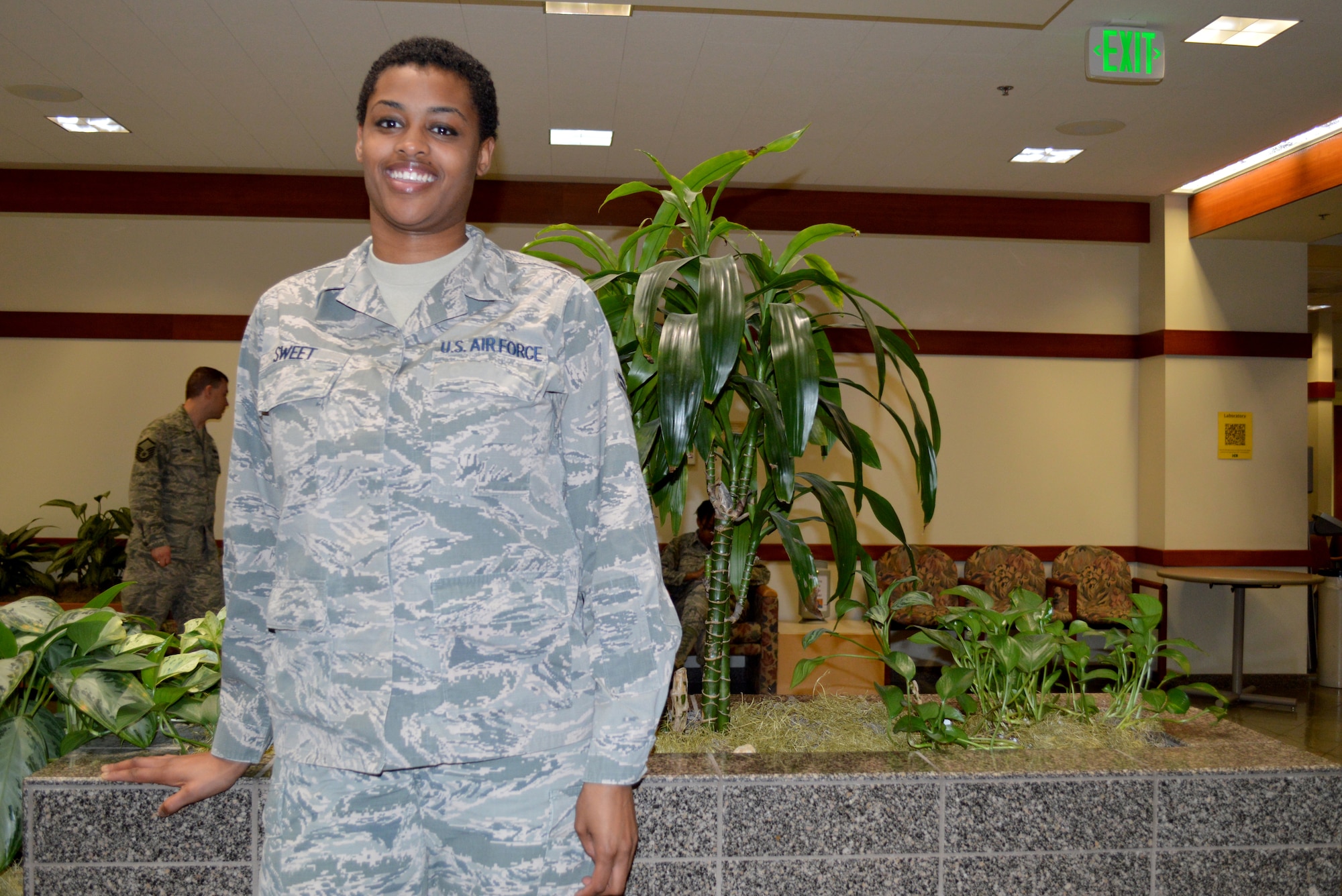 Airman 1st Class Kandyce Sweet, member of the 477th Aerospace Medicine Flight, is all smiles as she checks in patients and provides customer service during a preventative health assessment May 2.