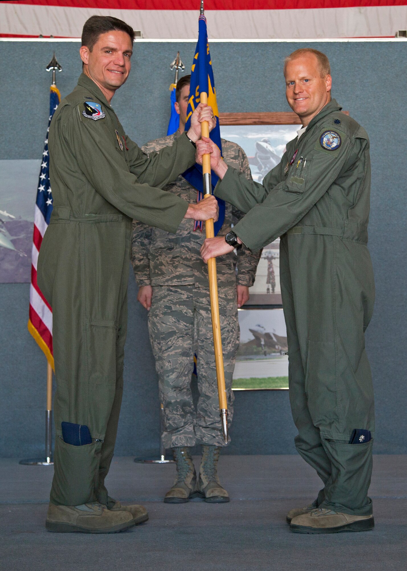 Col. Rodney Todaro (left), 412th Operations Group commander, passes the 416th Flight Test Squadron guidon to Lt. Col. Darren Wees who assumed command of the 416th FLTS May 5 at Hangar 1630E. (U.S. Air Force photo by Christian Turner)