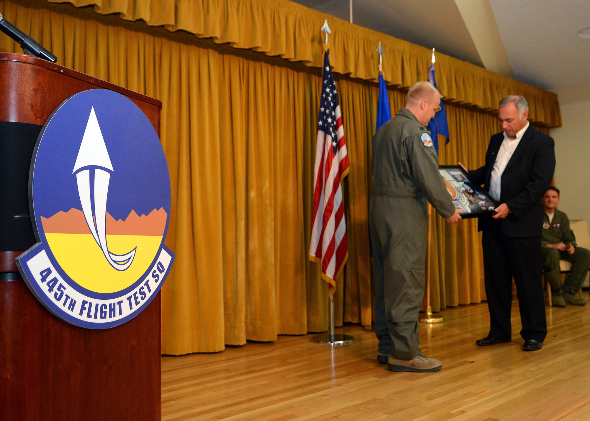 During the 445th Flight Test Squadron inactivation ceremony, Lt. Col. Darren Wees (left), 445th FLTS commander, can be seen presenting retired Lt. Col. Troy Fontaine, former 445th FLTS commander, with a squadron memento on May 1 at Club Muroc. The memento was given to Fontaine in honor of the squadron he stood up in 2002. The 445th Flight Test Squadron has been consolidated into three other Combined Test Forces. (U.S. Air Force photo by Jet Fabara)