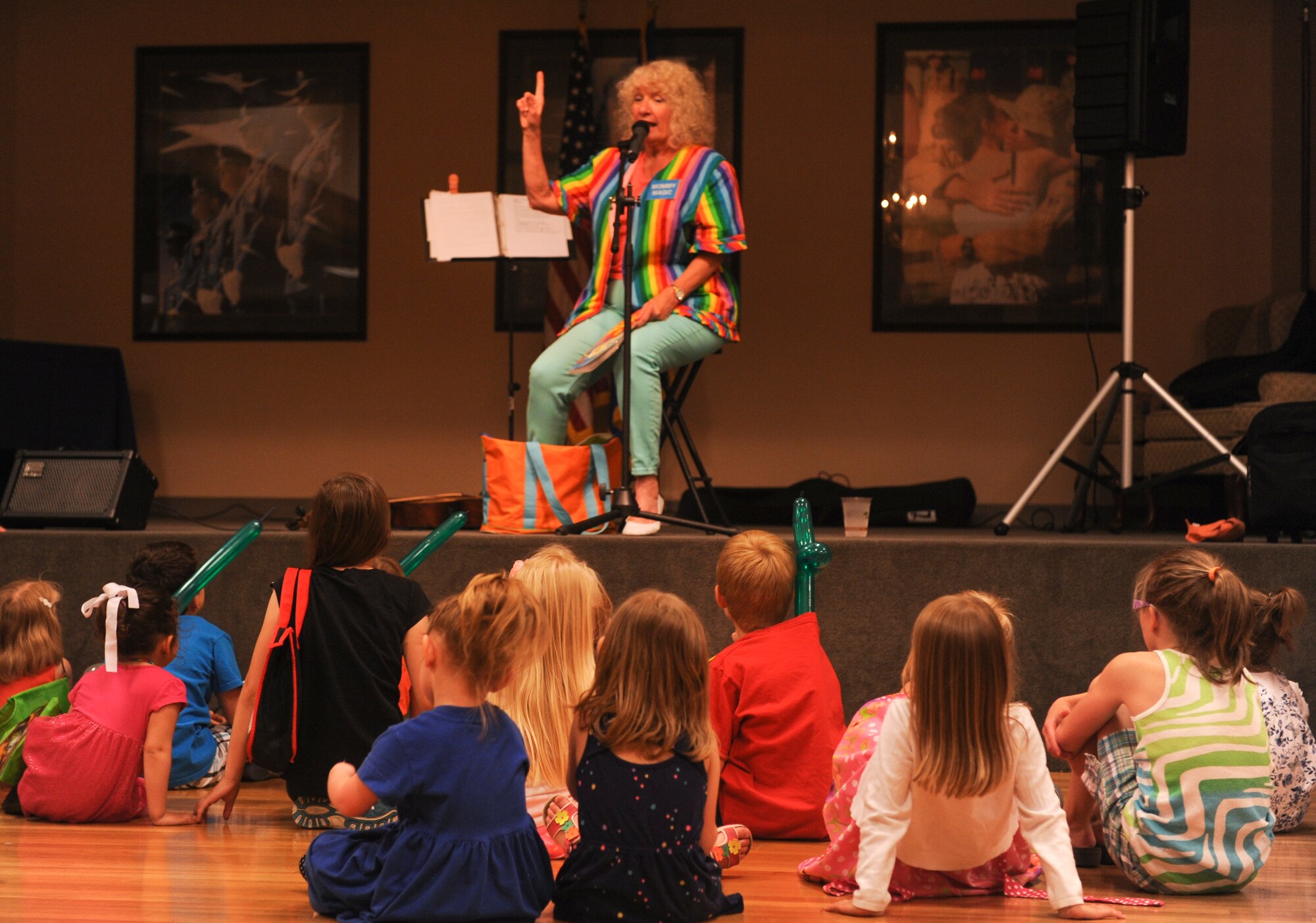 Pam Mendez, a clown, entertainer and ventriloquist, shares a story to children at the Deployed Family Dinner May 5, 2015, at Little Rock Air Force Base, Ark. The event is a way for base leadership to show their appreciation for deployed families for their support to the mission. (U.S. Air Force photo by Senior Airman Scott Poe) 