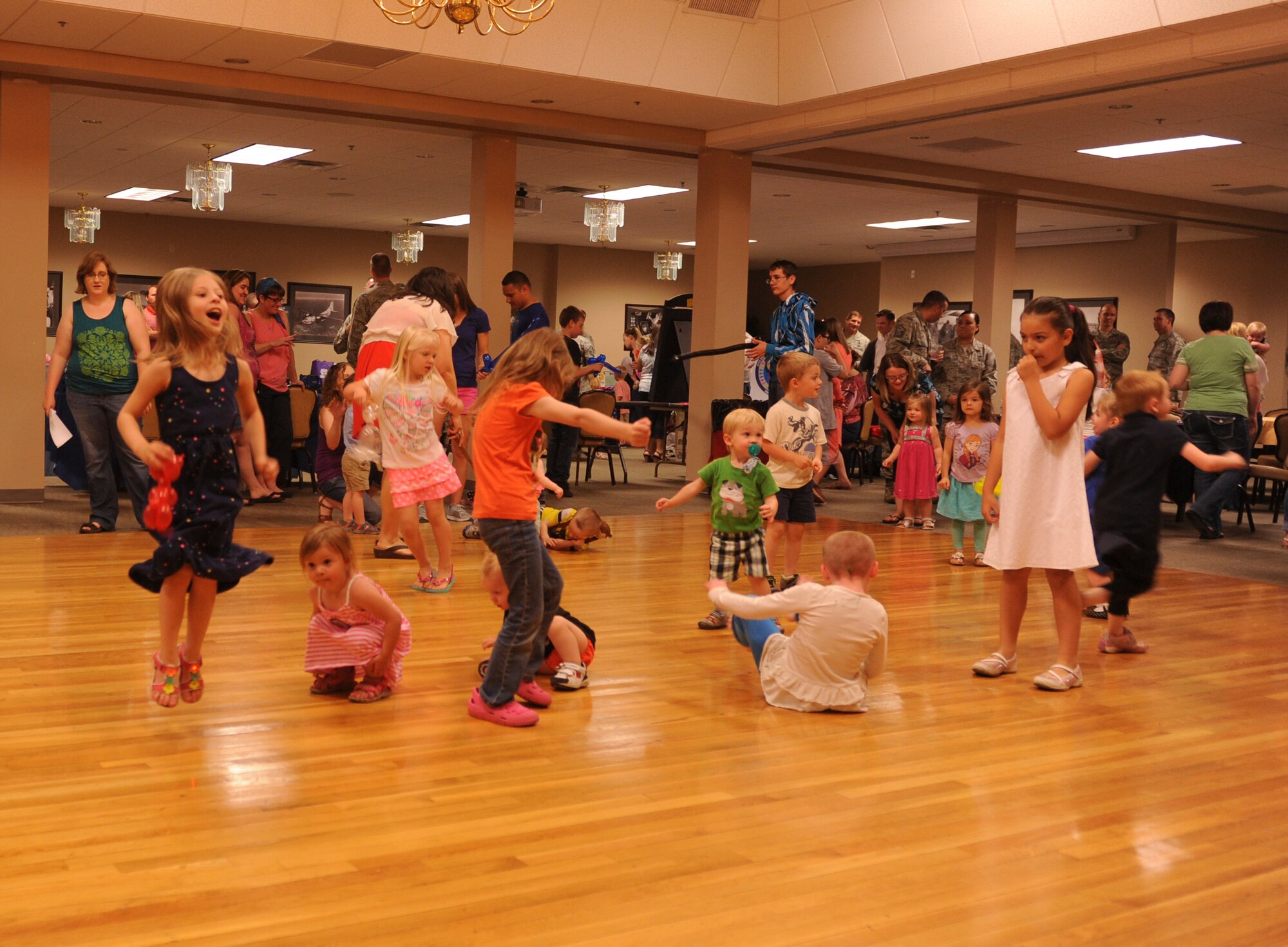 Children dance to the music of Pam Mendez, a clown, entertainer and ventriloquist, May 5, 2015, at Little Rock Air Force Base, Ark. The quarterly dinner gives families of deployed Airmen a chance to get together for a free meal and to receive information and assistance while separated from their loved ones. (U.S. Air Force photo by Senior Airman Scott Poe))