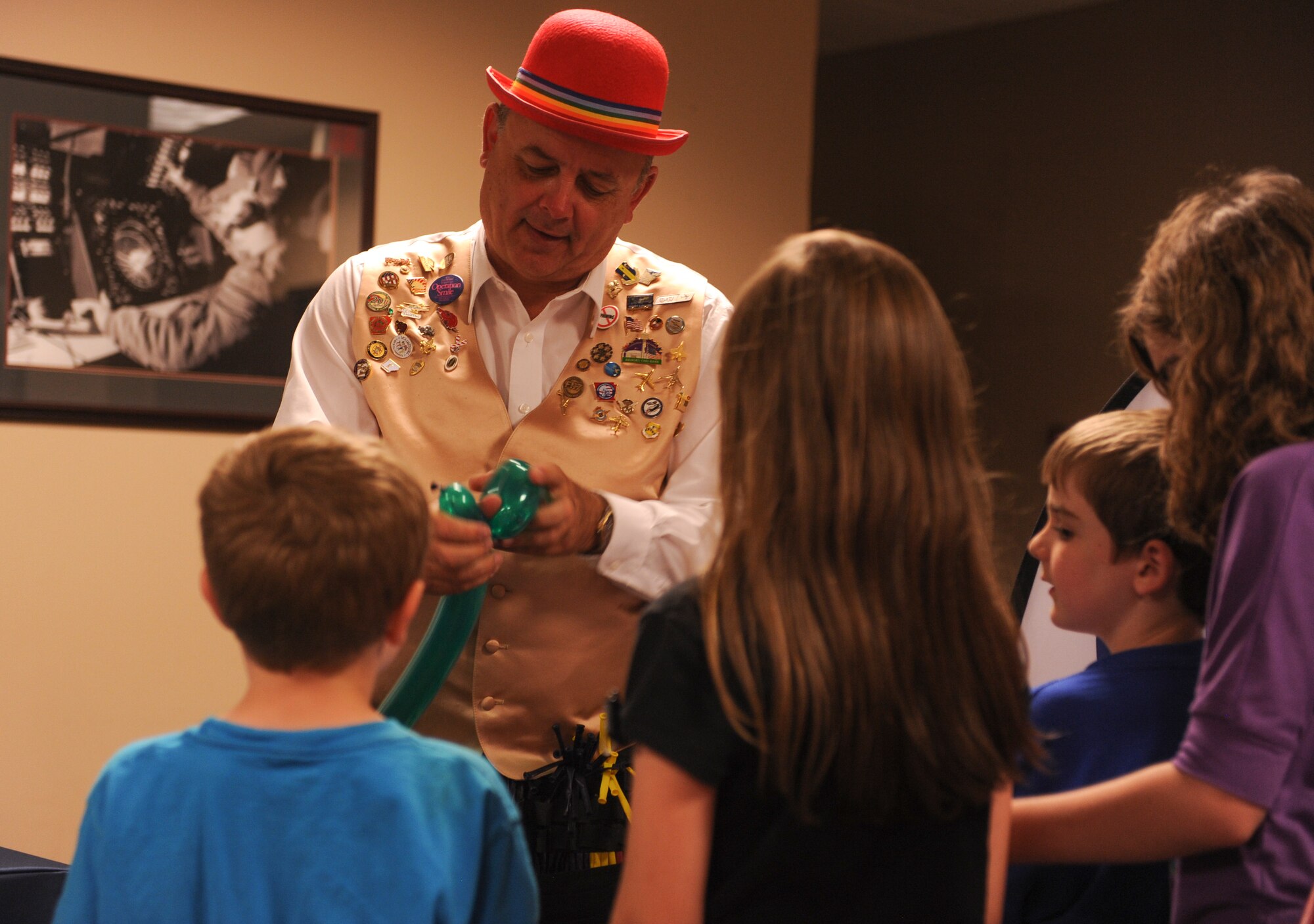 Ken Keplinger volunteers to make balloon animals for children at the Deployed Family Dinner May 5, 2015, at Little Rock Air Force Base, Ark. Children were lined up from one end of the room to the other to receive balloon animals and other creations. (U.S. Air Force photo by Senior Airman Scott Poe)