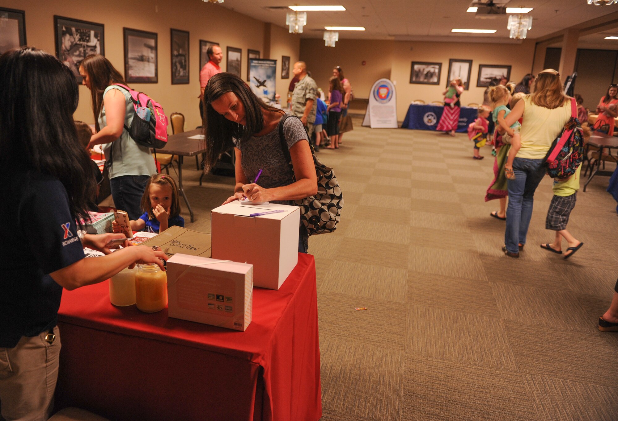 Team Little Rock spouses visit informational booths during the Deployed Family Dinner hosted by the Chapel May 5, 2015, at Little Rock Air Force Base, Ark. The quarterly Deployed Family Dinner, brings families together and gives parents a short break and free meal. (U.S. Air Force photo by Senior Airman Scott Poe)