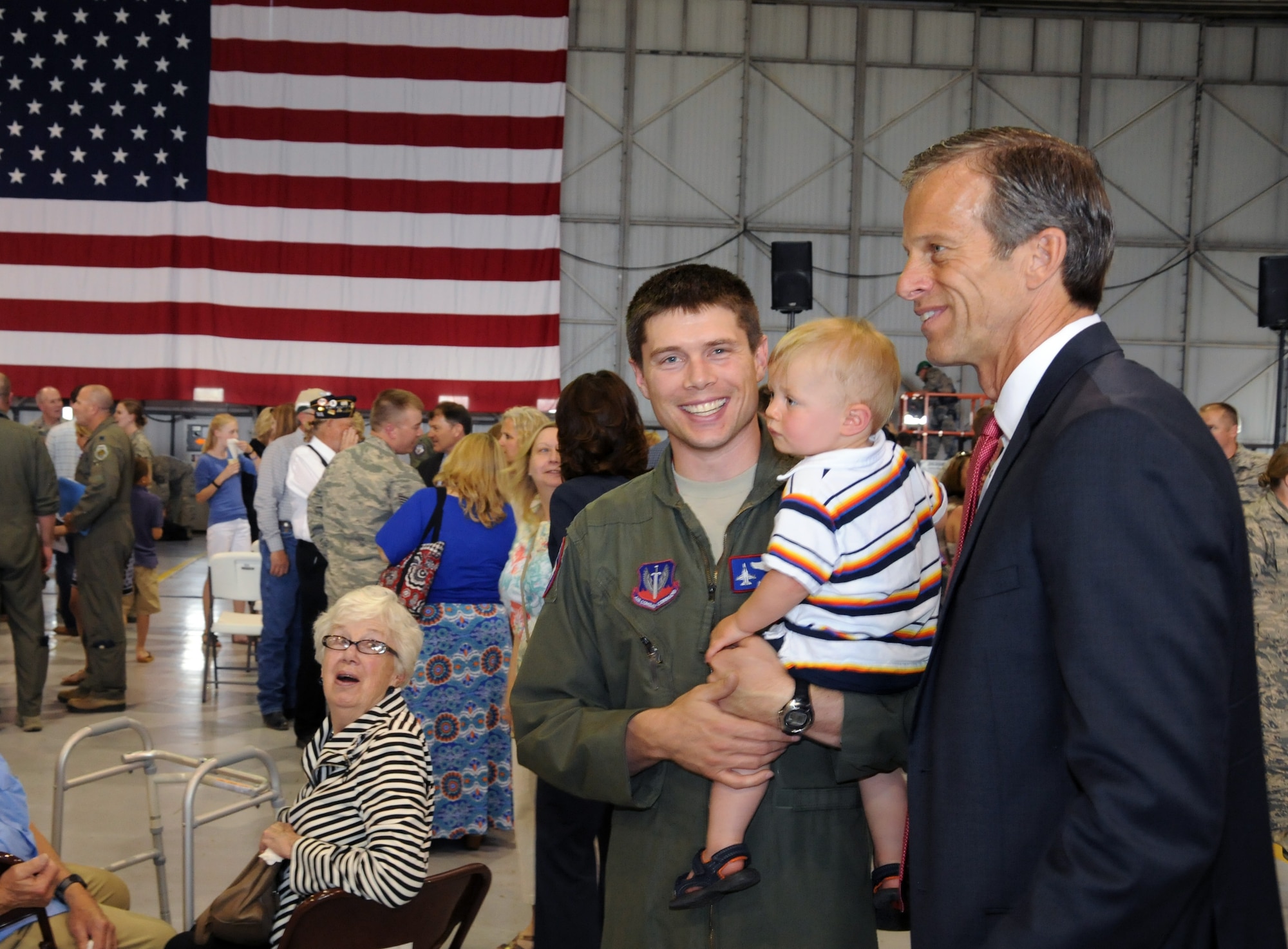 U.S. Sen. John Thune of South Dakota takes a minute to visit with U.S. Air Force Capt. Casey Minor, 175th Fighter Squadron pilot, and his family to thank them for their service after a mobilization ceremony held at Joe Foss Field, S.D., May 3, 2015. Minor will be among the almost 250 members of the South Dakota Air National Guard unit who are slated to deploy to South Korea in support of a rotational Theater Security Package. (U.S. Air National Guard photo by Staff Sgt. Luke Olson)