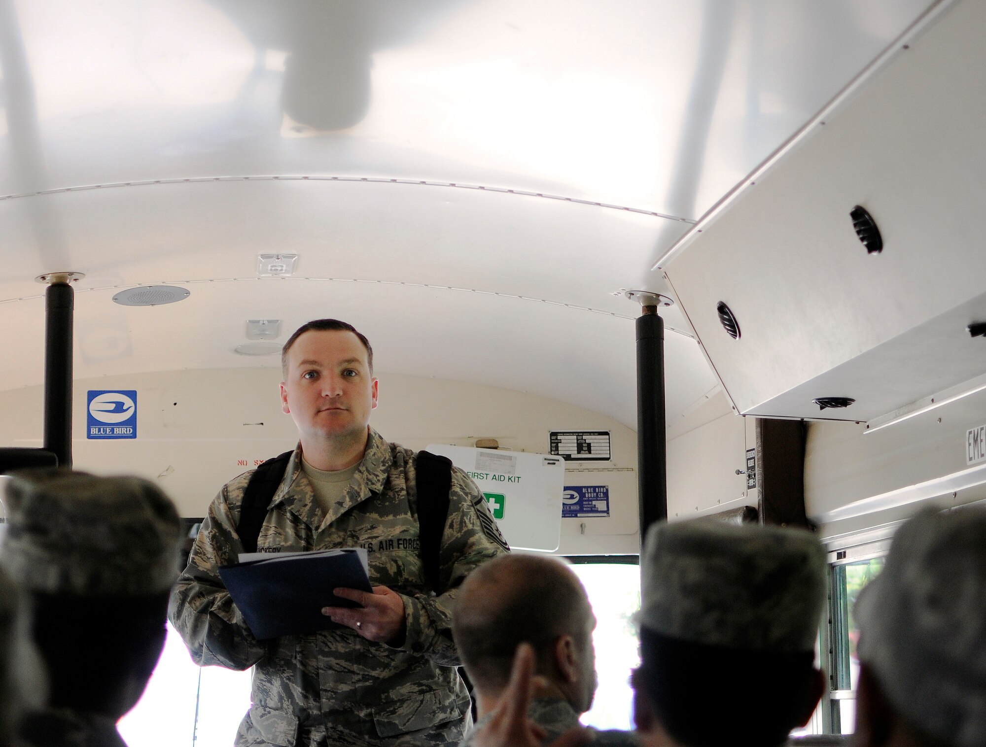 Oregon Air National Guard Master Sgt. Robert Vickery, first sergeant, 142nd Fighter Wing Civil Engineer Squadron (CES) conducts a role call of squadron members as they board a bus  at the Portland Air National Guard Base, Ore., May 5, 2015. The 142nd CES is taking part in a mission to Romania to rebuild an aging hospital as part of US European Command's Humanitarian Assistance Program. (U.S. Air National Guard photo by Staff Sgt. Brandon Boyd, 142nd Fighter Wing Public Affairs/Released)