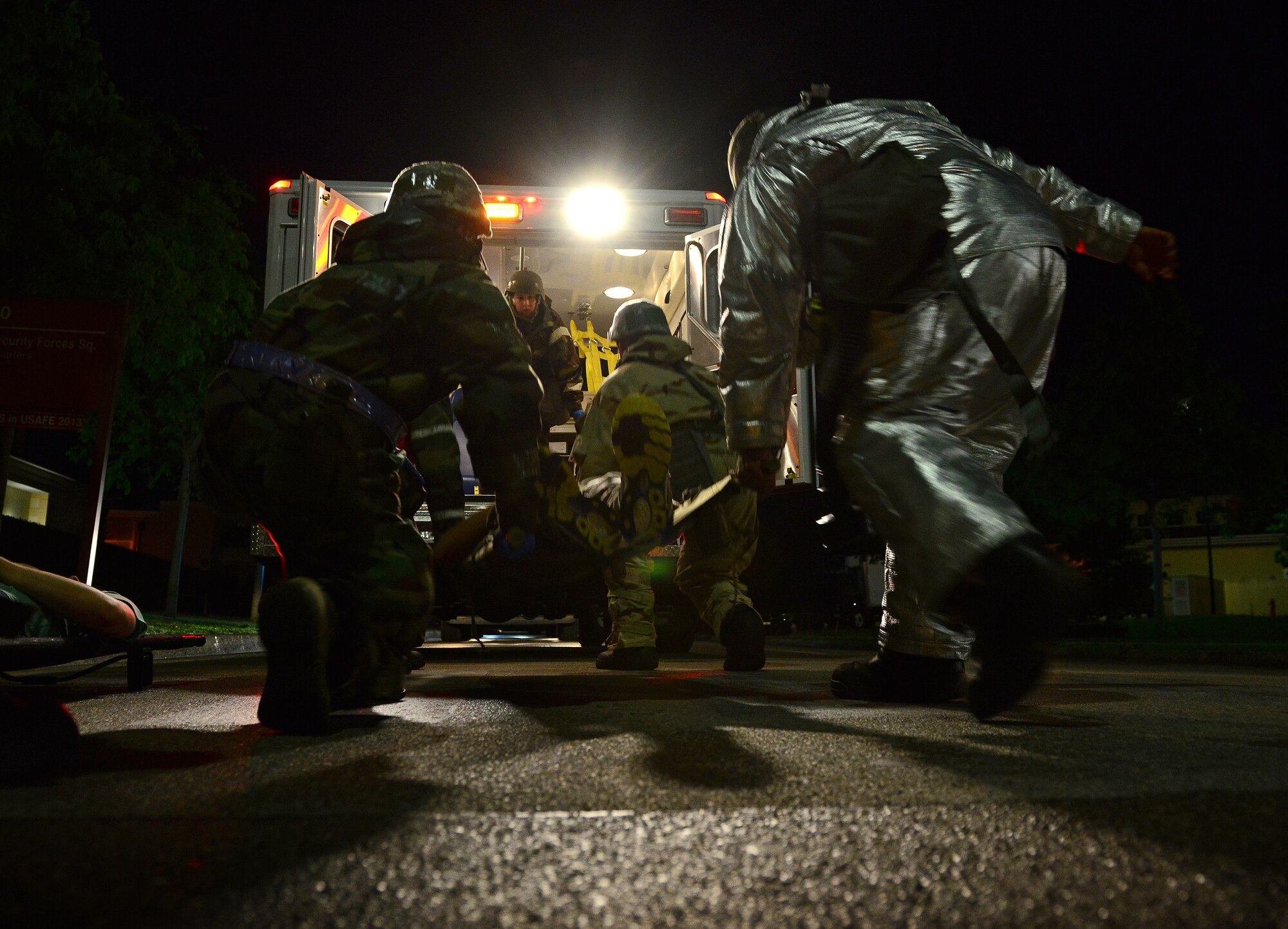U.S. Air Force Airmen from the 31st Medical Group and Security Forces Squadron carry a simulated casualty to an ambulance, during MAROON EXCAVATOR, May 7, 2015, at Aviano Air Base, Italy. The training tested Airmen’s abilities to work together, perform self-air buddy care and transport injured personnel to safety. (U.S. Air Force photo by Senior Airman Matthew Lotz/Released)
