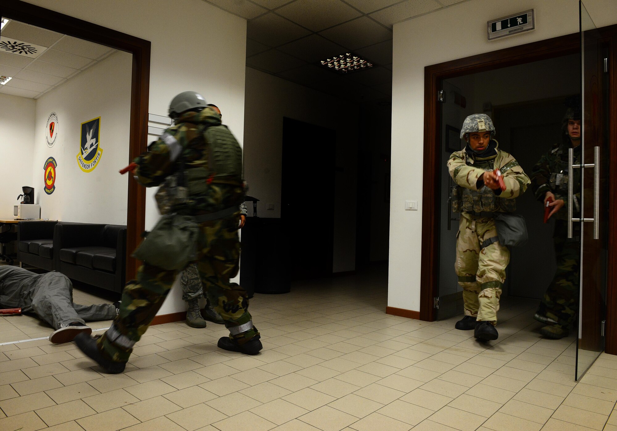 U.S. Air Force security forces members from the 31st Security Forces Squadron clear a building during an active shooter training scenario for inspection MAROON EXCAVATOR, May 7, 2015, at Aviano Air Base, Italy. The training tested Airmen’s abilities to work together, perform self-air buddy care and transport injured personnel to safety. (U.S. Air Force photo by Senior Airman Matthew Lotz/Released)