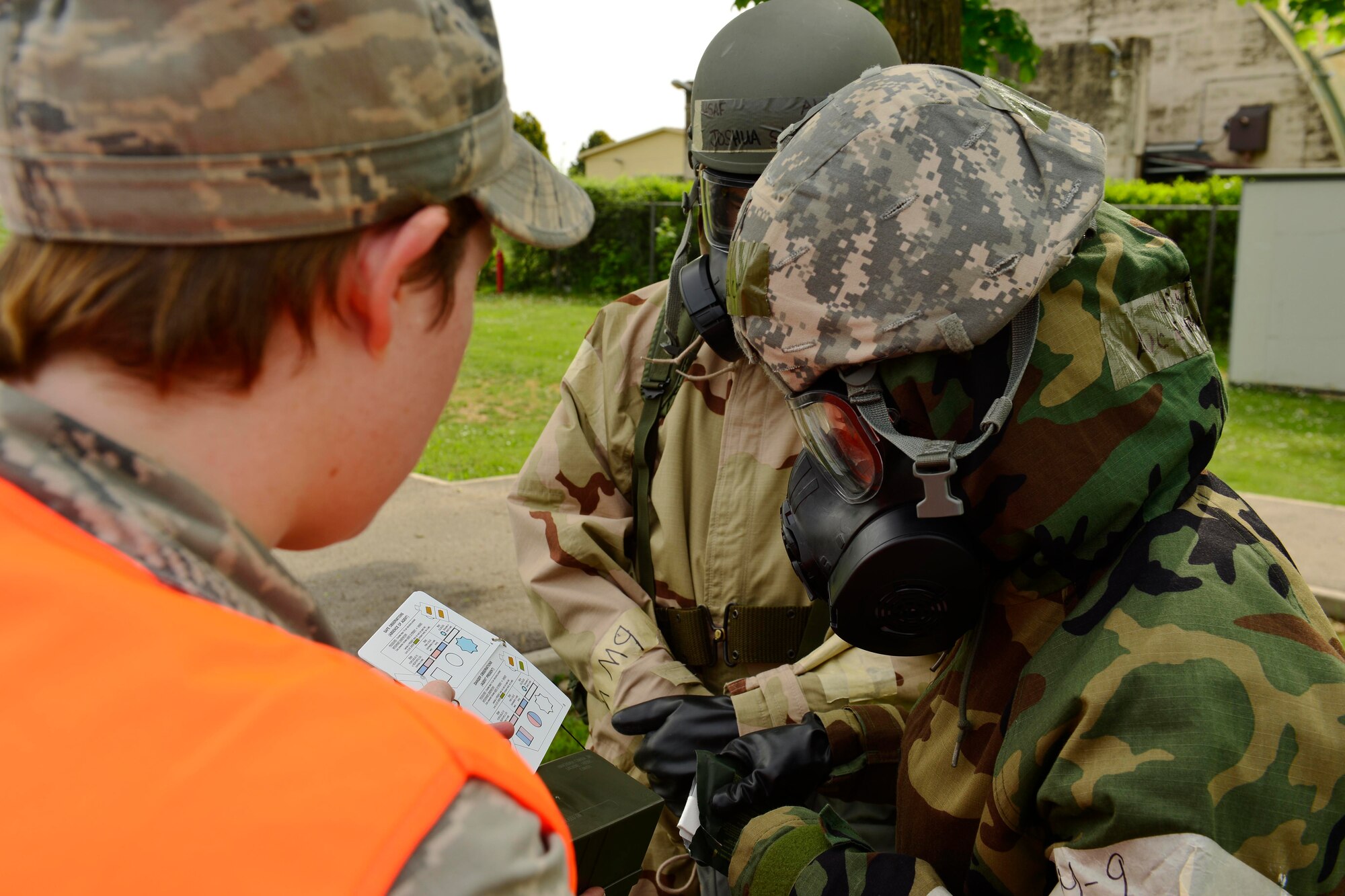 U.S. Air Force Senior Airman Molly Clune, 31st Civil Engineer Squadron emergency management journeyman, assesses Airman 1st Class Emani Coe’s knowledge on the use of a nerve agent detector kit, during MAROON EXCAVATOR, May 5, 2015 at Aviano Air Base, Italy. Airmen were inspected on operational readiness procedures during a simulated post-attack reconnaissance sweep scenario. (U.S. Air Force photo by Airman 1st Class Cary Smith/Released)