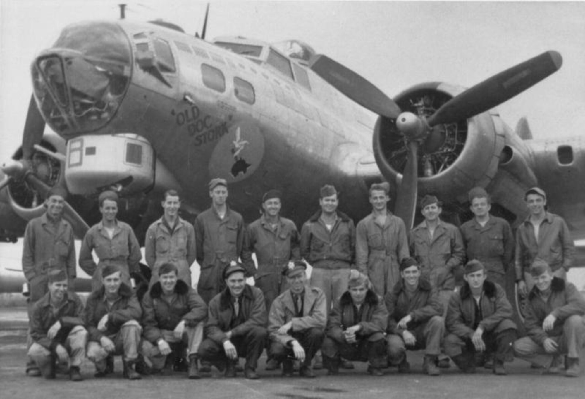 Combat and ground crew of the 490th Bomb Group with their B-17 Flying Fortress, nicknamed "Old Doc Stork," pose for a photograph during World War II. After the group's conversion to B-17s, the crew switched focus and flew longer distance missions over Germany to bomb industrial sites. After Victory in Europe Day, the group dropped food supplies to flooded parts of Holland and transported French, Belgian and Spanish prisoners of war out of Austria. (Photo and caption courtesy of American Air Museum in Britain website)