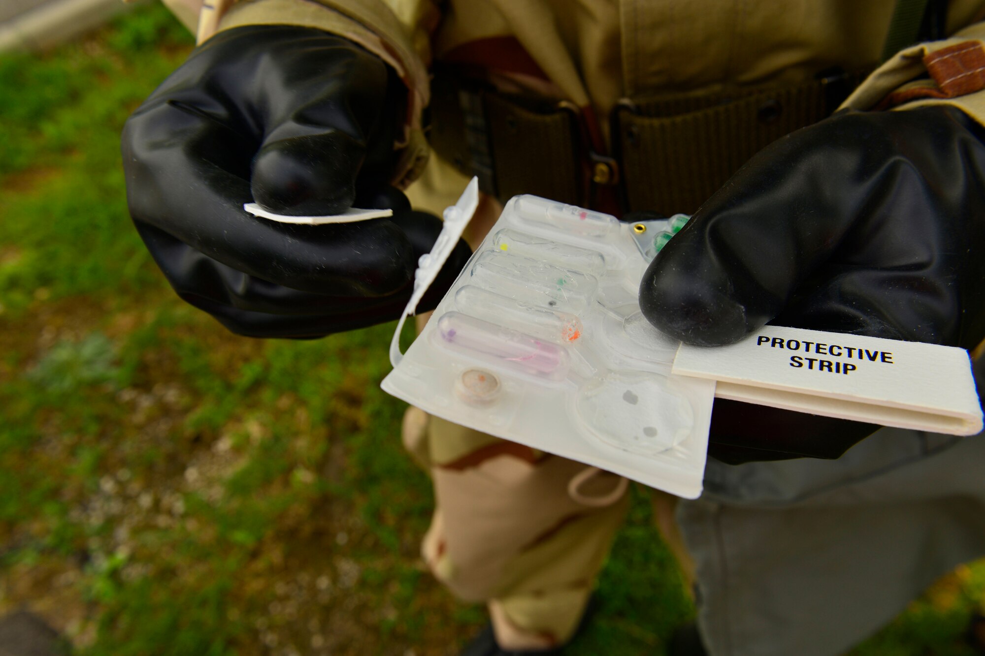 U.S. Air Force Airman 1st Class Joshua Sheard, 31st Civil Engineer Squadron structural technician, tests the air for simulated nerve agents, during MAROON EXCAVATOR, May 5, 2015 at Aviano Air Base, Italy.  Airmen were inspected on operational readiness procedures during a simulated post-attack reconnaissance sweep scenario.  (U.S. Air Force photo by Airman 1st Class Cary Smith/Released)