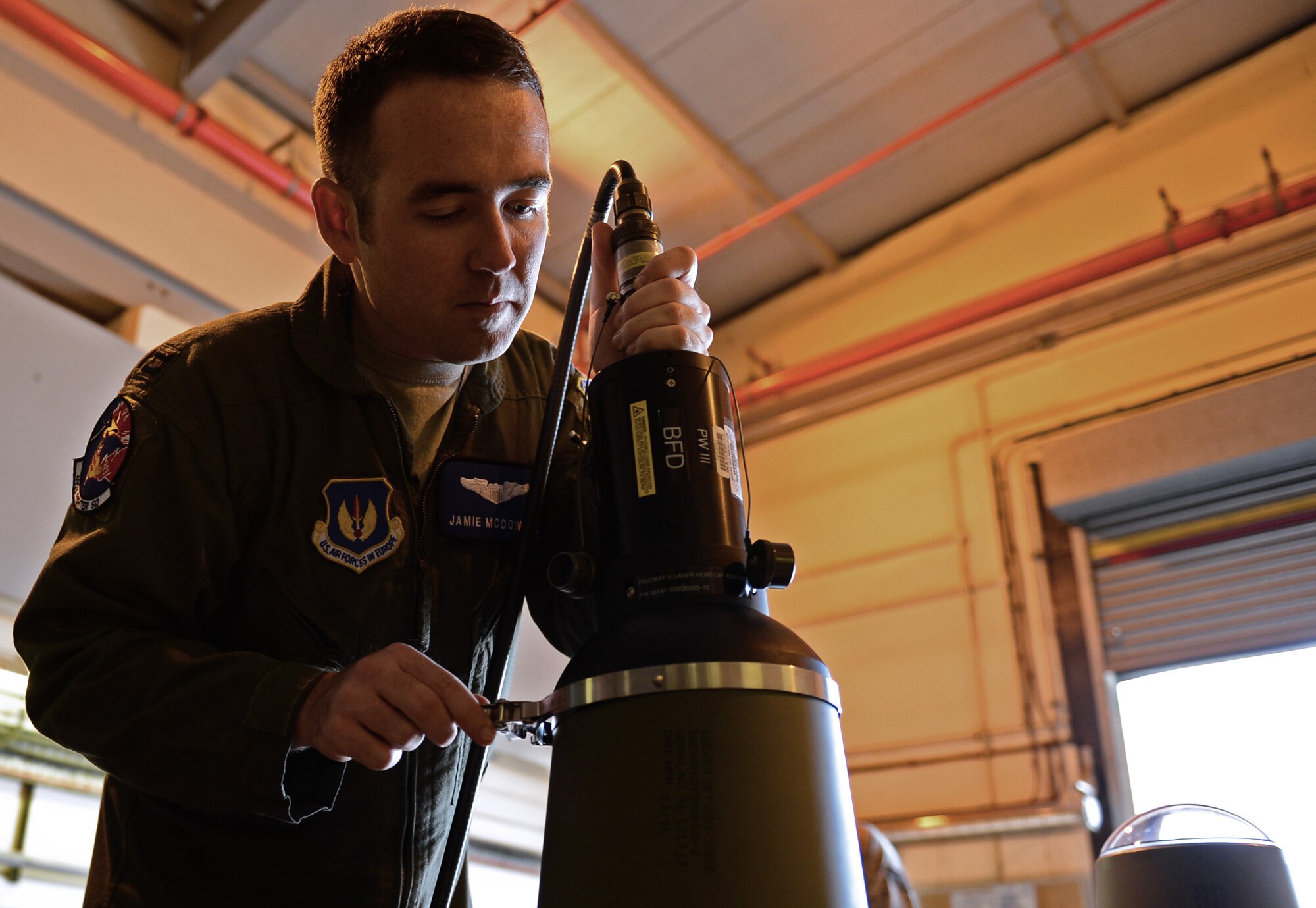 Captain Jamie McDowall, 492nd Fighter Squadron F-15E Strike Eagle pilot, connects a TTU-595 test set to a Weapon Guidance Unit-39 guidance control unit at Royal Air Force Lakenheath, England, May 4, 2015. Aircrew from the 492nd FS participated in a munitions immersion event with the 48th Munitions Squadron to build eight Guided Bomb Unit-24 low-level, laser-guided bombs. (U.S. Air Force photo by Airman 1st Class Erin R. Babis/Released)