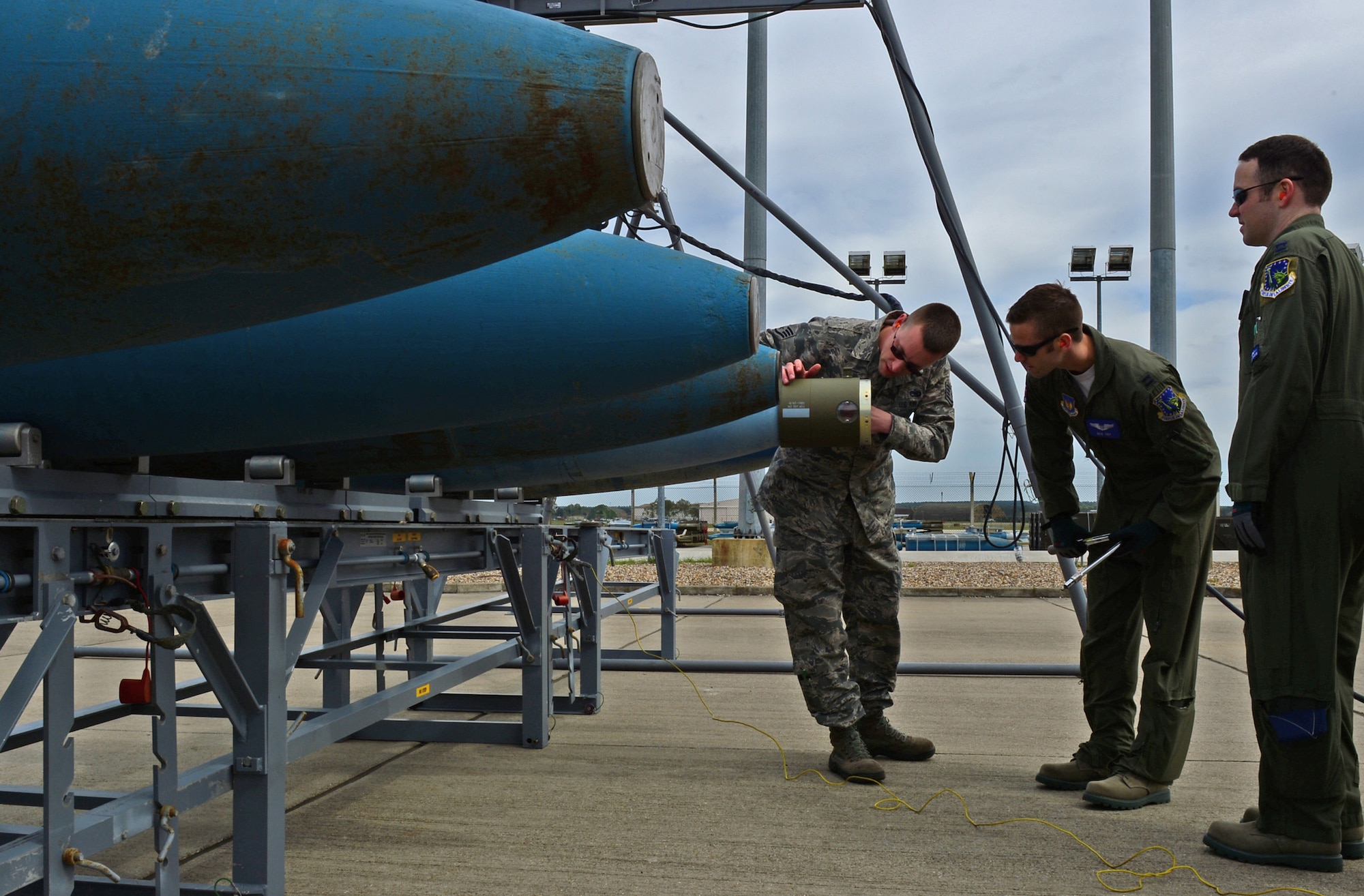 Staff Sgt. Shane Thielmann, 48th Munitions Squadron conventional maintenance crew chief, explains to Captains Nicholas Eby and Jamie McDowall, 492nd Fighter Squadron aircrew, how to properly fit the forward adapter onto a Guided Bomb Unit-24 at Royal Air Force Lakenheath, England, May 4, 2015. The bomb-build immersion event gave aircrew participants a cradle-to-grave understanding of the weapons they utilize, while promoting synergy between the operations and maintenance groups. (U.S. Air Force photo by Airman 1st Class Erin R. Babis/Released)
