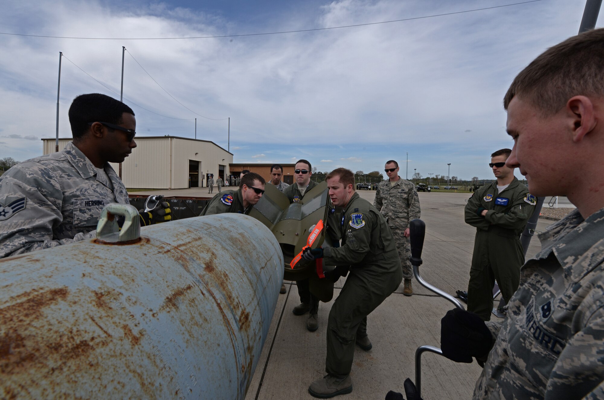 Airmen from the 48th Munitions Squadron assist aircrew from the 492nd Fighter Squadron in attaching a Bomb Stabilizer Unit-84 wing assembly at Royal Air Force Lakenheath, England, May 4, 2015. Aircrew from the 492nd FS participated in a munitions immersion event with the 48th MUNS to build eight Guided Bomb Unit-24 low-level, laser-guided bombs. (U.S. Air Force photo by Airman 1st Class Erin R. Babis/Released)
