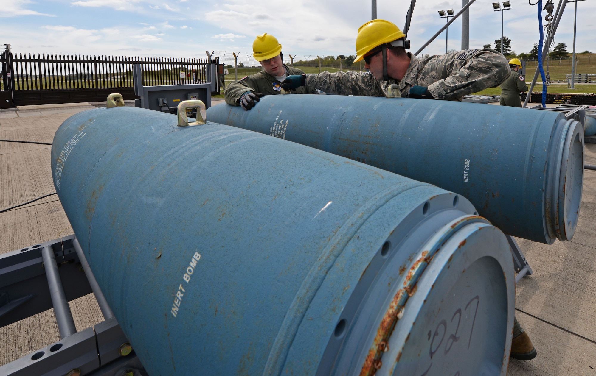 Staff Sgt. Andrew Rice, 48th Munitions Squadron conventional maintenance crew chief, teaches Capt. Harry Starnes lll, 492nd Fighter Squadron F-15E Strike Eagle pilot, to inspect a Bomb Dummy Unit-56 bomb body from at Royal Air Force Lakenheath, England, May 4, 2015. Aircrew from the 492nd FS participated in a munitions immersion event with the 48th Munitions Squadron to build eight Guided Bomb Unit-24 low-level, laser-guided bombs. (U.S. Air Force photo by Airman 1st Class Erin R. Babis/Released)