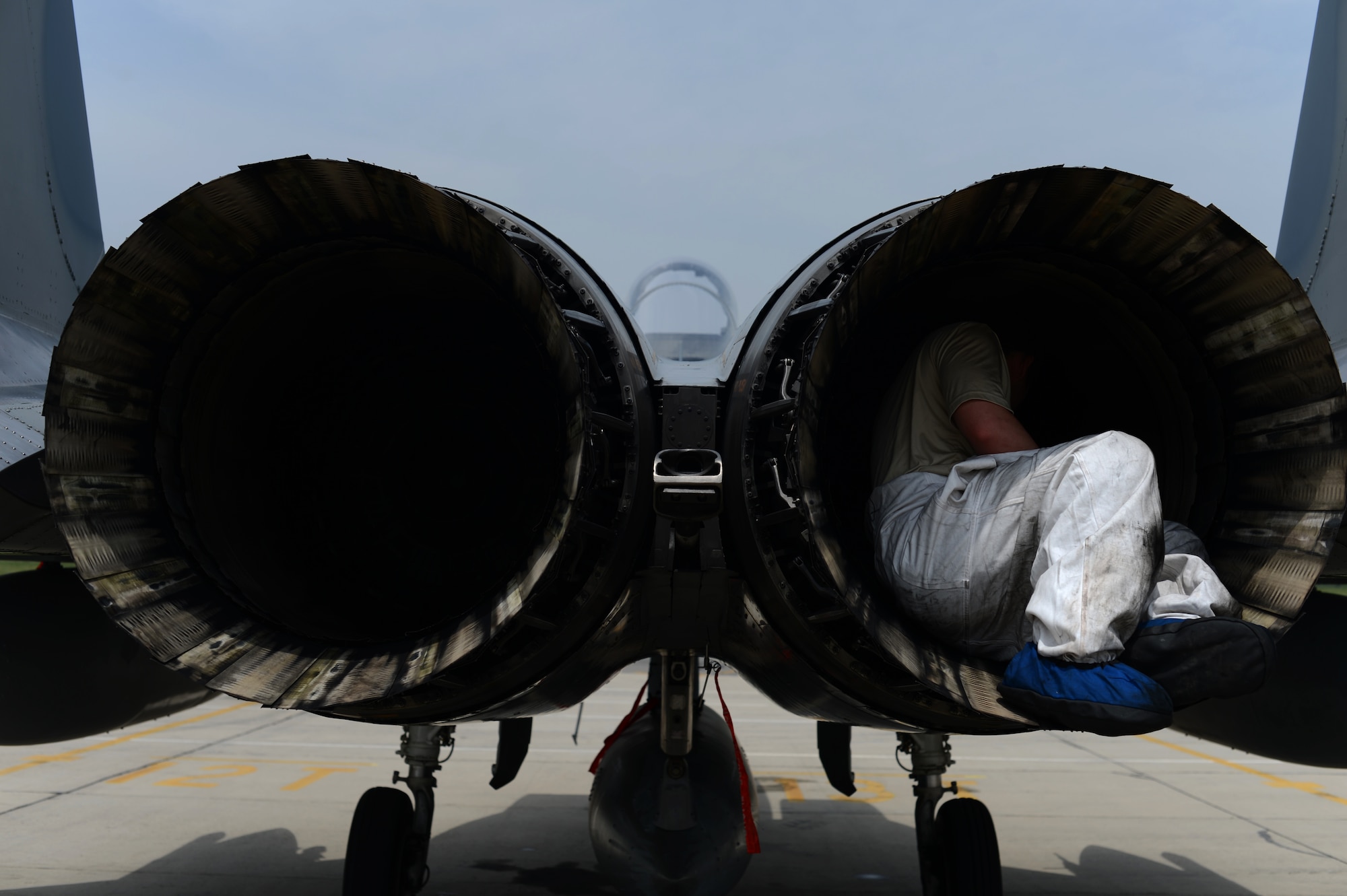 U.S. Air Force Tech. Sgt. Christopher Lemley, 159th Expeditionary Fighter Squadron crew chief, examines the inside of an F-15 Eagle fighter aircraft engine on the flightline at Graf Ignatievo Air Base, Bulgaria, May 7, 2015. While in Bulgaria, the 159th EFS will conduct routine flying and training with the Bulgarian Air Force to enhance interoperability and support NATO security and stability. (U.S. Air Force photo by Senior Airman Gustavo Castillo/Released)