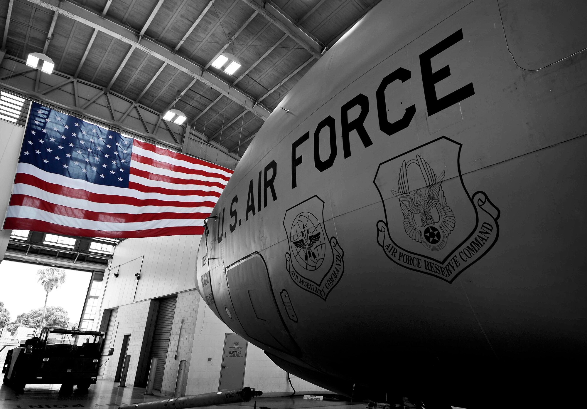 An American flag hangs in front of a KC-135 Stratotanker in Hangar 1 at MacDill Air Force Base, Fla., April 28, 2015.  For more than 200 years, the American flag has been the symbol of our nation’s strength and unity. (U.S. Air Force illustration by Senior Airman Melanie Bulow-Gonterman/Released)   