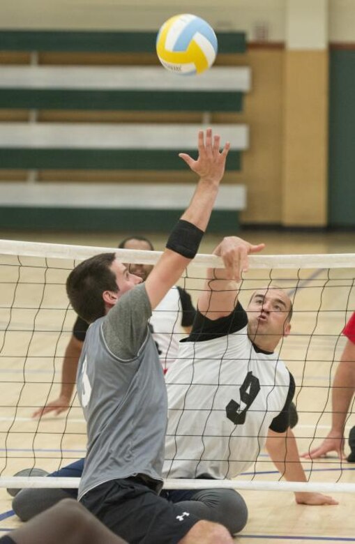 U.S. Army Capt. Joe Colón, Jr., left, Warrior Transition Unit Soldier, participates in a seated volleyball game at Fort Bliss, Texas, April 1, 2015. Colón tried out for several Warrior Games Army Team sports including, seated throws, archery and seated volleyball.  (Courtesy Photo)