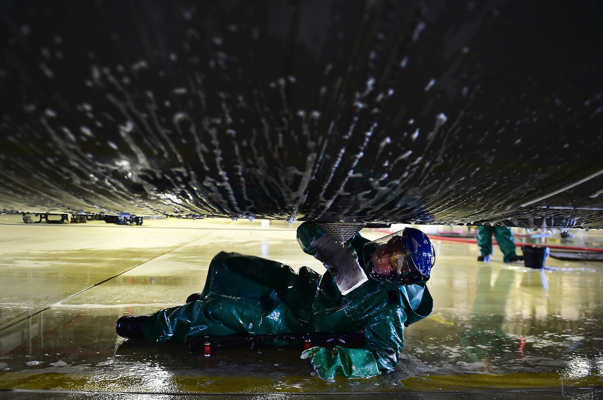 An Airman from the 86th Aircraft Maintenance Squadron washes the underside of a C-130J Super Hercules April 20, 201,5 at Ramstein Air Base, Germany. Aircraft washing is a vital part of the flying mission, and if not washed regularly, aircraft begin to corrode and cause damage yielding it unsafe to operate. (U.S. Air Force photo/Staff Sgt. Sara Keller)