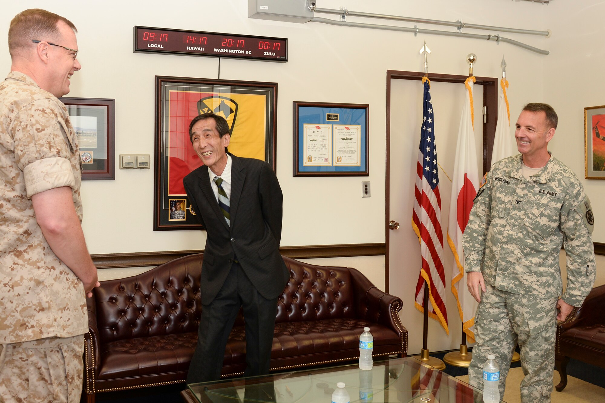 Brig. Gen. Mark Wise, deputy commander of U.S. Forces, Japan, left, and Col. Cory Mendenhall, chief of staff of USFJ, right, meet with artist Ikuo Ohsawam, April 30, 2015 at Yokota Air Base, Japan. Mendenhall invited Ohsawa to the 5th Air Force headquarters to view Ohsawa’s donated art for the first time in ten years. (U.S. Air Force photo by Airman 1st Class Elizabeth Baker/Released) 