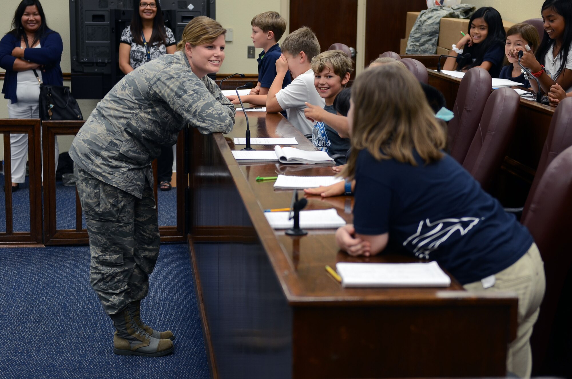 Capt. Natalie Cepak, 36th Wing officer in charge of civil law, discusses the mock trial’s deliberation with Andersen Elementary School fourth graders in the base courtroom May 1, 2015, at Andersen Air Force Base, Guam. The 36th Wing Paralegal team acted out an Alice in Wonderland-themed mock trial for Law Day, May 1, to explain the importance of the Magna Carta. (U.S. Air Force photo by Airman 1st Class Alexa Ann Henderson/Released)