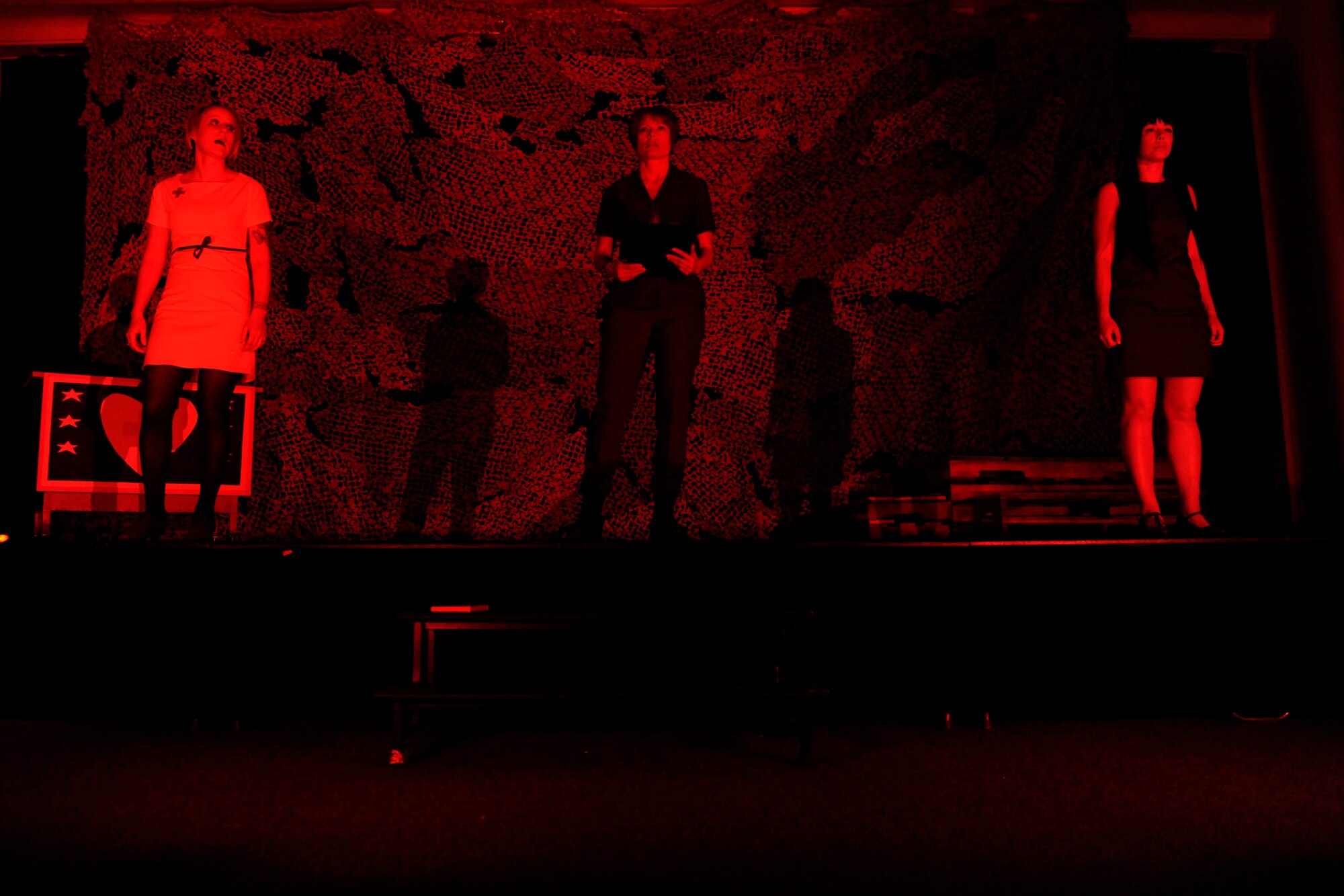 Sydney King, 39th Air Base Wing Chapel Protestant parish coordinator (Left), Senior Master Sgt. Shiloh Slater, 39th Logistics Readiness Squadron superintendent (Middle), and Airman 1st Class Jessica Hoyle, 39th Medical Operations Squadron medical technician, perform a scene during the Incirlik Fine Arts Society’s spring play, ‘A Piece of My Heart’ April 29, 2015, at Incirlik Air Base, Turkey. Throughout the development of the show, cast members not only acted, but also designed and built sets, developed costumes and promoted the show. (U.S Air Force photos by Senior Airman Krystal Ardrey/Released) 