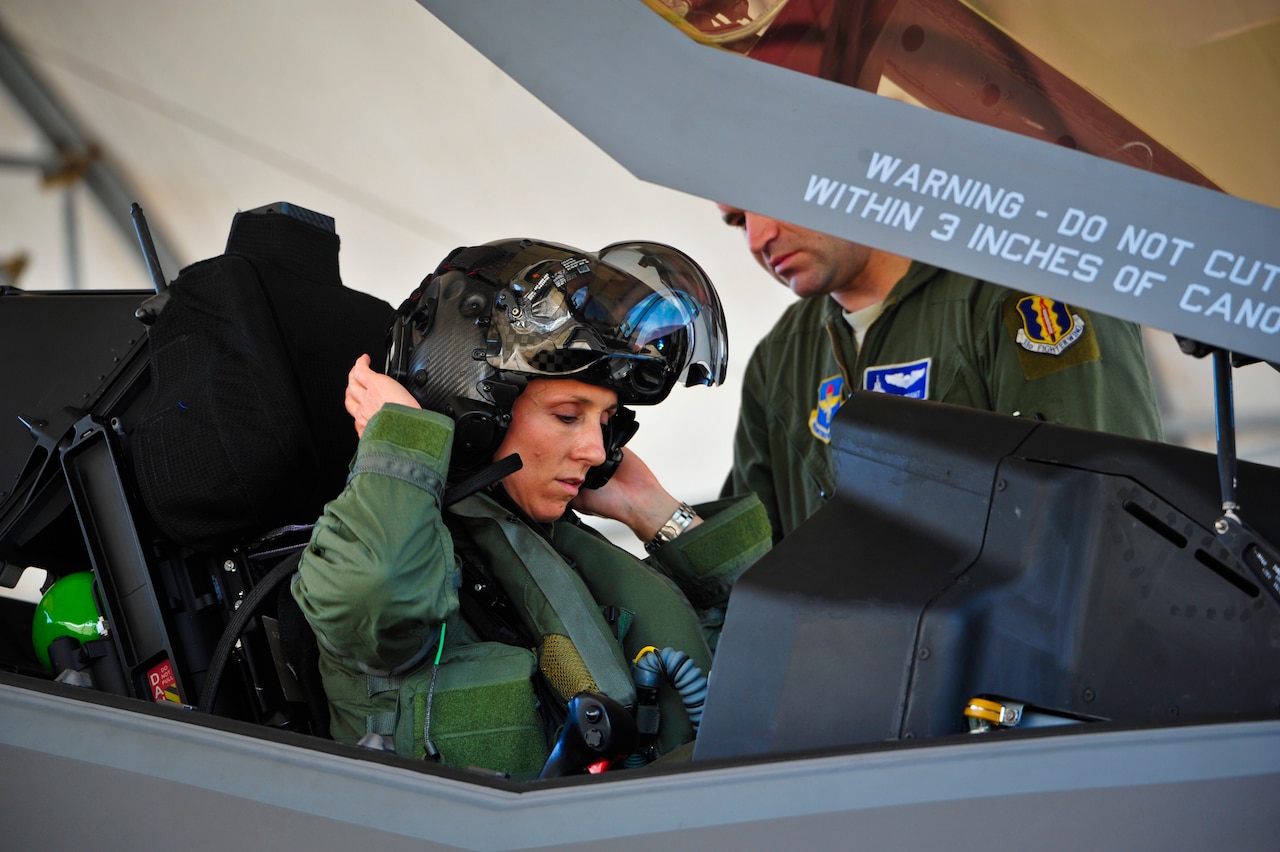 Air Force Lt. Col. Christine Mau, 33rd Operations Group deputy commander, puts on her helmet before taking her first flight in the F-35A Lightning II joint strike fighter at Eglin Air Force Base, Fla., May 5, 2015. Mau, who previously flew F-15E Strike Eagles, made history as the first female F-35 pilot in the program. U.S. Air Force photo by Staff Sgt. Marleah Robertson