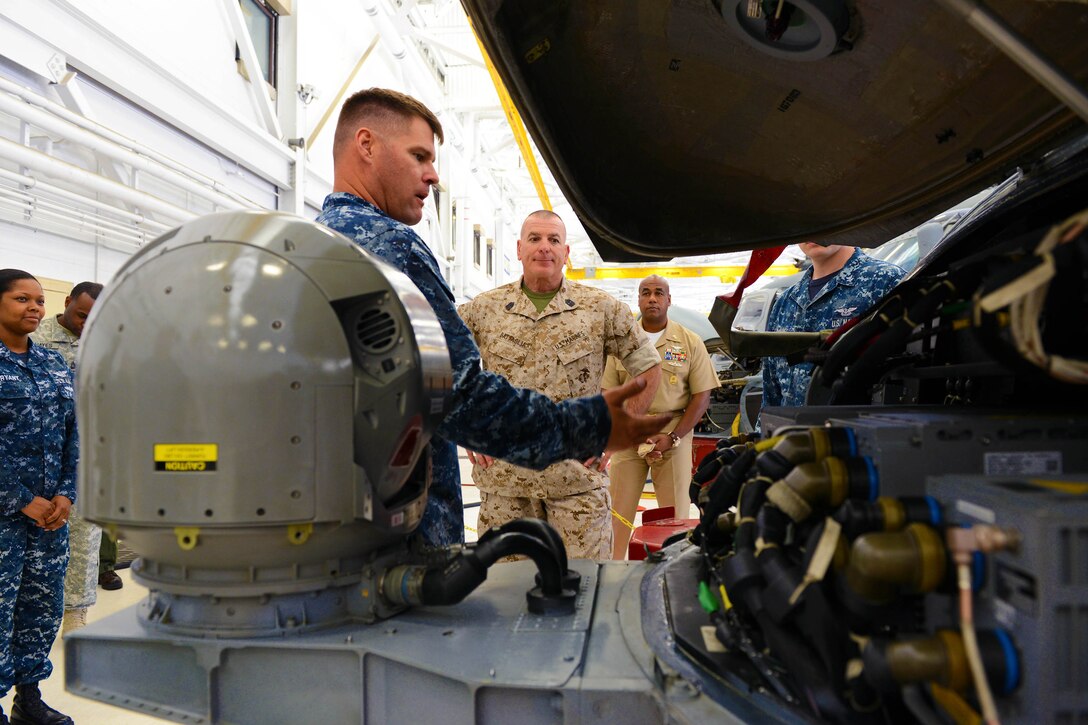 Marine Corps Sgt. Maj. Bryan B. Battaglia, the U.S. military’s top senior enlisted leader, is briefed on the capabilities of the MH-60R Seahawk helicopter by a Navy crew from Helicopter Maritime Strike Squadron 70, “Spartans,” at Naval Air Station Jacksonville, Fla., May 4, 2015. Battaglia toured the base as part of a six-day visit to the region. 