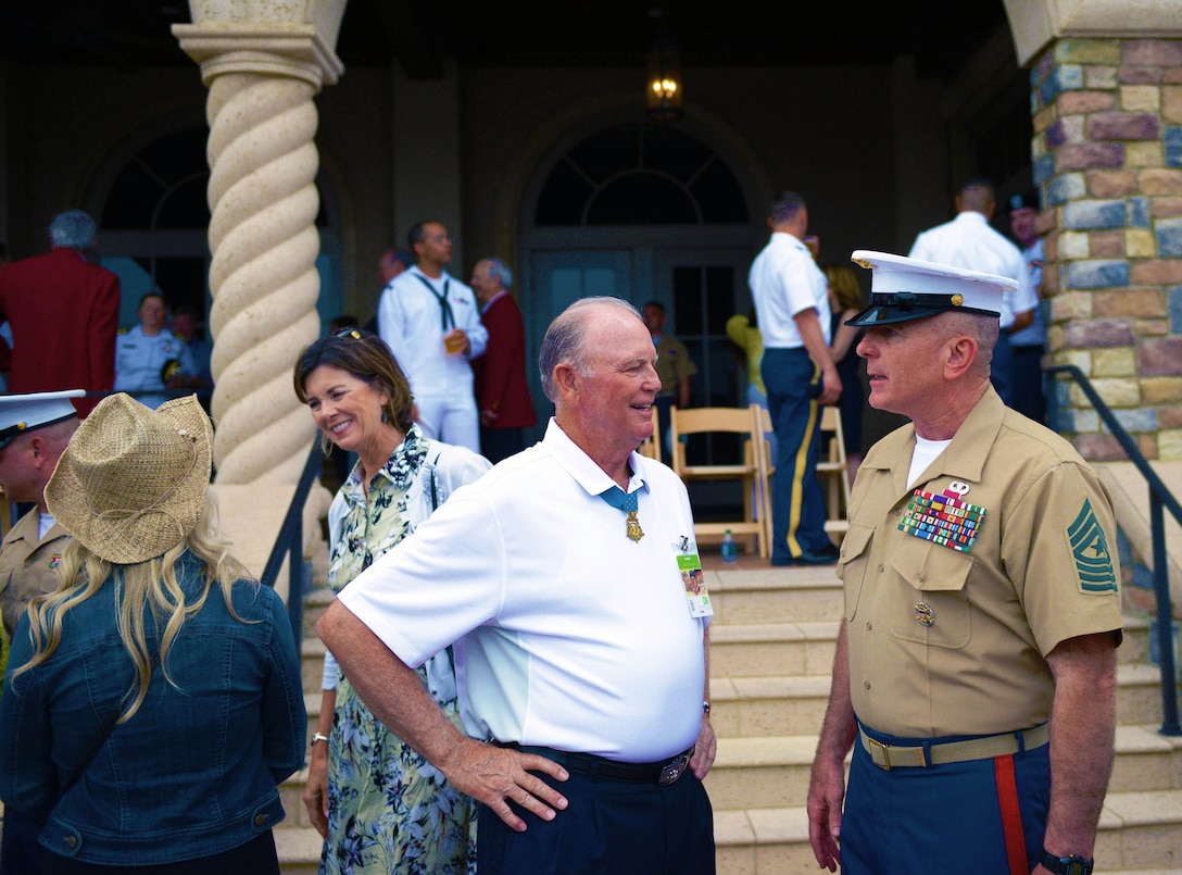 Retired Army Lt. Col. Ronald E. Ray, left, a Vietnam War Congressional of Honor recipient, talks with Marine Corps Sgt. Maj. Bryan B. Battaglia, during the PGA Tour and The Players Championship’s Military Appreciation Day in Ponte Vedra Beach, Fla., May 5, 2015. Ray earned his Medal of Honor while serving with the 25th Infantry Division. 