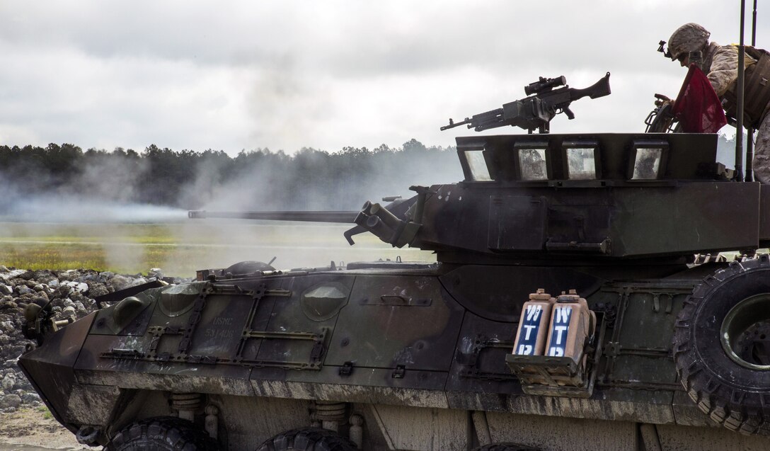 A light armored vehicle crew fires at a target during a pre-qualification range at Marine Corps Base Camp Lejeune, N.C., May 1, 2015. During the exercise, the crew on the LAV moved from position to position to engage several targets and were evaluated on their accuracy, timeliness and effectiveness in identifying the target that presented the highest threat. The Marines are assigned to the 2nd Marine Division's Charlie Company, 2nd Light Armored Reconnaissance Battalion.