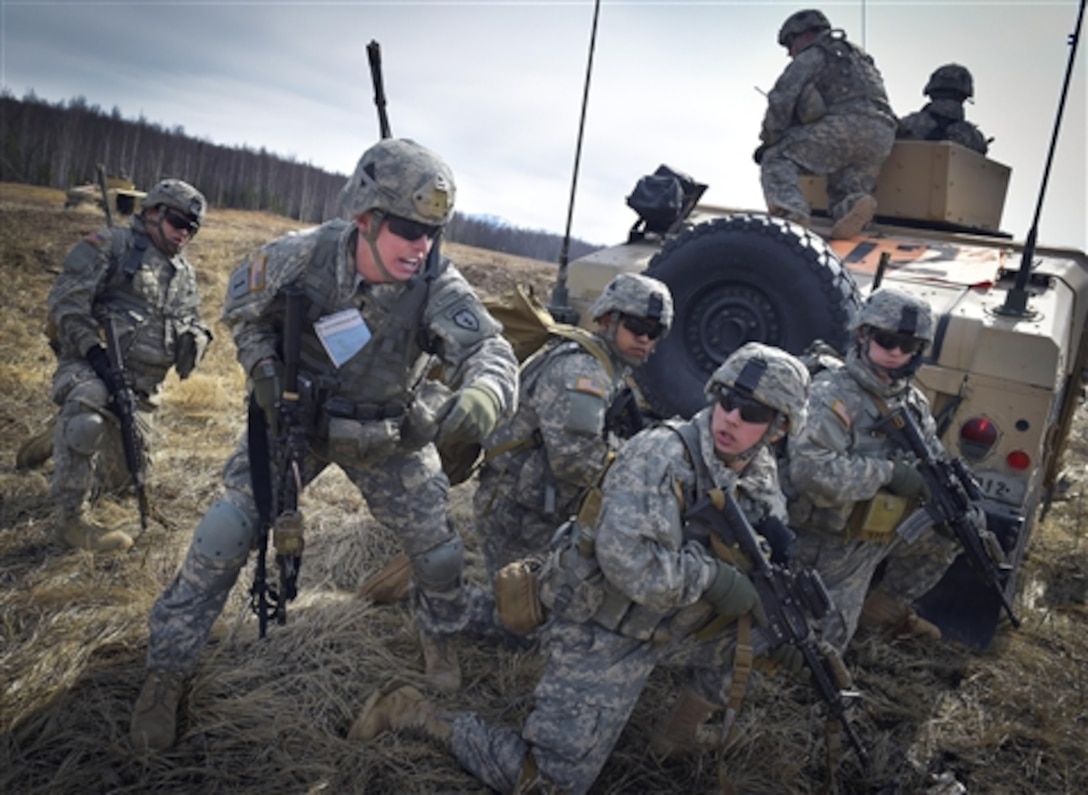 Army 1st Lt. Stephen Schnorf, left center, orders his soldiers to assault a simulated enemy position during a heavy weapons live-fire exercise on Joint Base Elmendorf-Richardson in Anchorage, Alaska, April 24, 2015. Schnorf is assigned to the 25th Infantry Division's Company D, 1st Battalion, 501st Infantry Regiment, 4th Brigade Combat Team. 