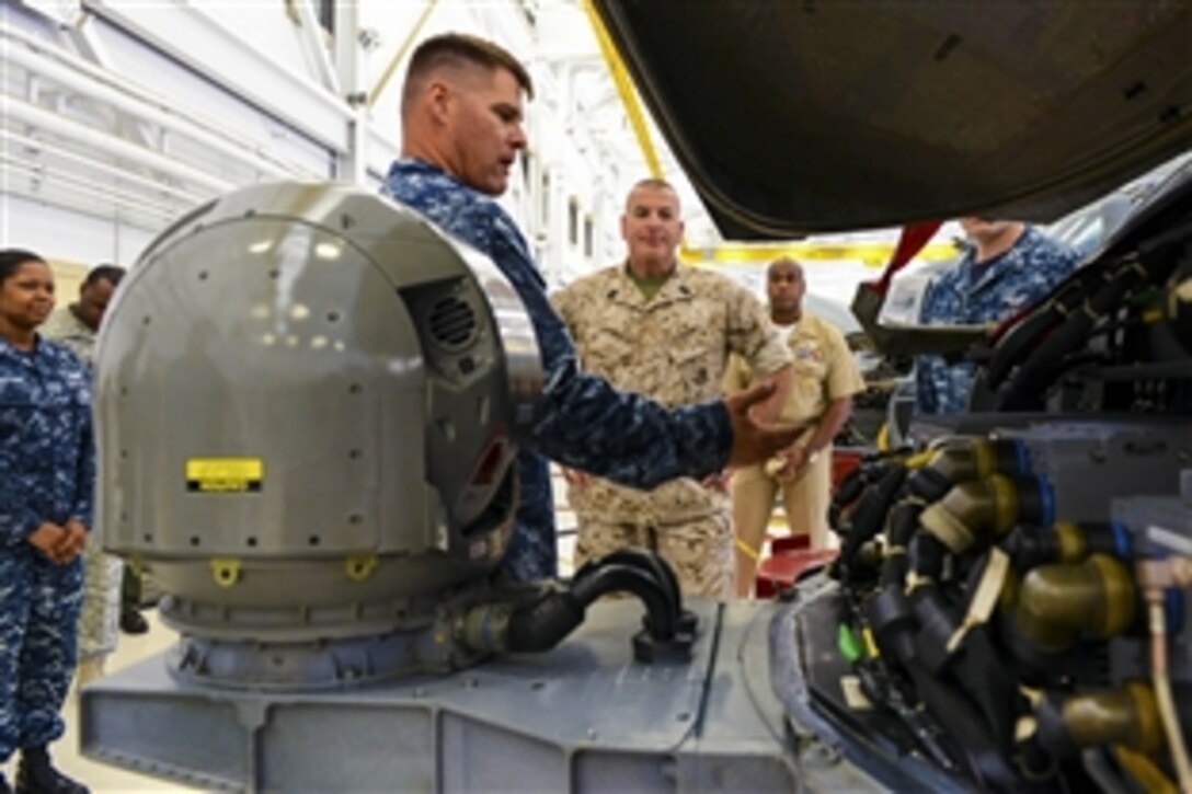 Marine Corps Sgt. Maj. Bryan B. Battaglia, the U.S. military’s top senior enlisted leader, receives a briefing on the capabilities of the MH-60R Seahawk helicopter from a Navy crew member assigned Helicopter Maritime Strike Squadron 70 on Naval Air Station Jacksonville, Fla., May 4, 2015. Battaglia visited the base as part of a six-day visit to the region. 