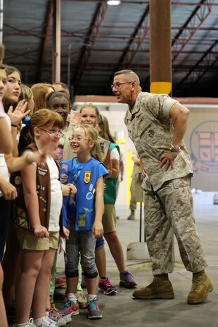 Maj. Gen. Robert F. Hedelund talks to 33 Girl Scouts about Operation Cookie Drop following the delivery of 8,400 Girl Scout cookies to Marine Corps Air Station Cherry Point, North Carolina, April 4, 2015. Hedelund is the commanding general, 2nd Marine Aircraft Wing.