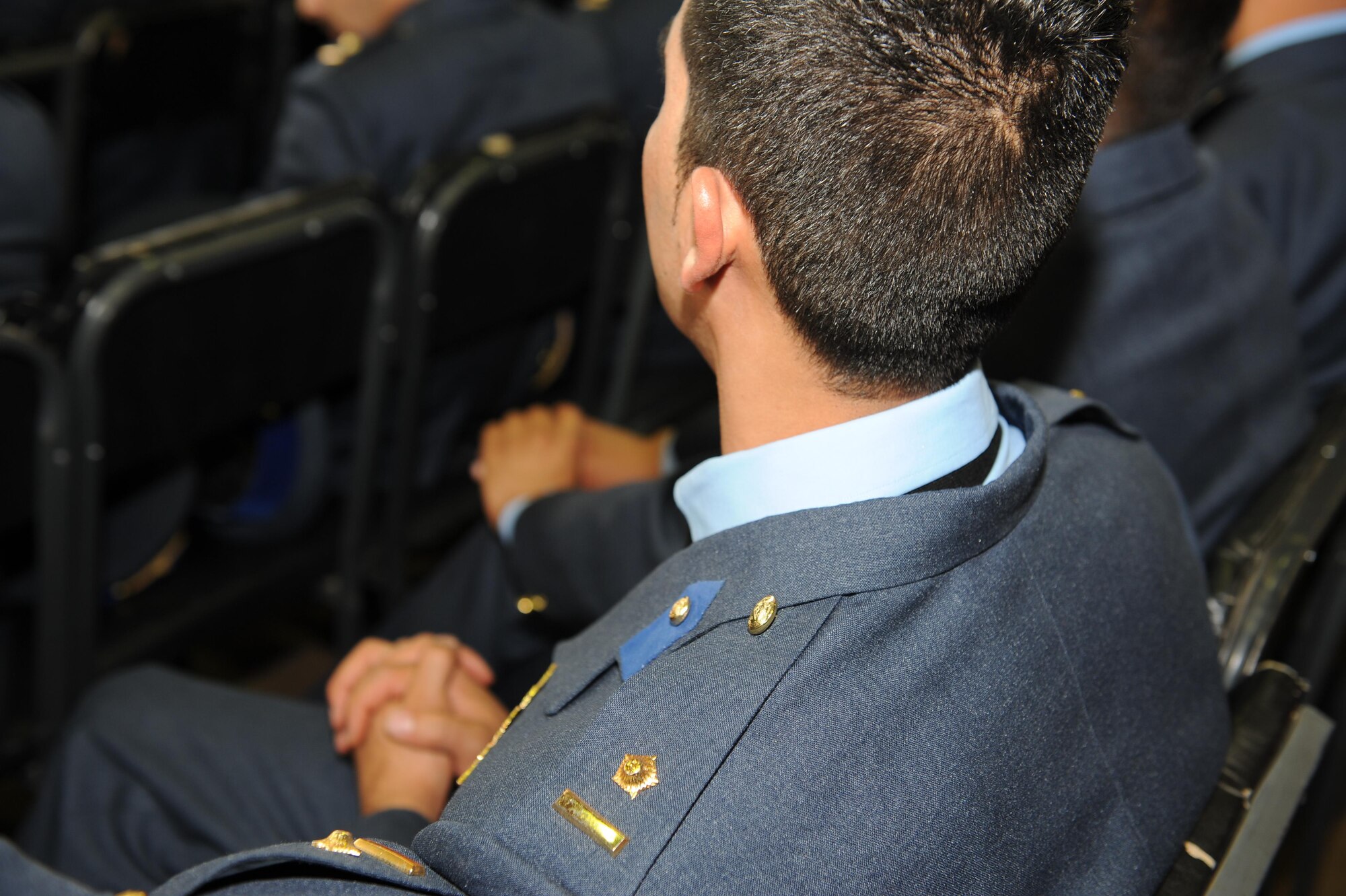 Soon to be graduates of the Afghan Air Force academy await to receive their diplomas during a ceremony, May 7, 2014. The ceremony marked the first graduation since the fall of the Taliban, adding 184 newly commissioned second lieutenants to the Afghan Air Force. (Official U.S. Air Force photo/Capt. Jeff M. Nagan)