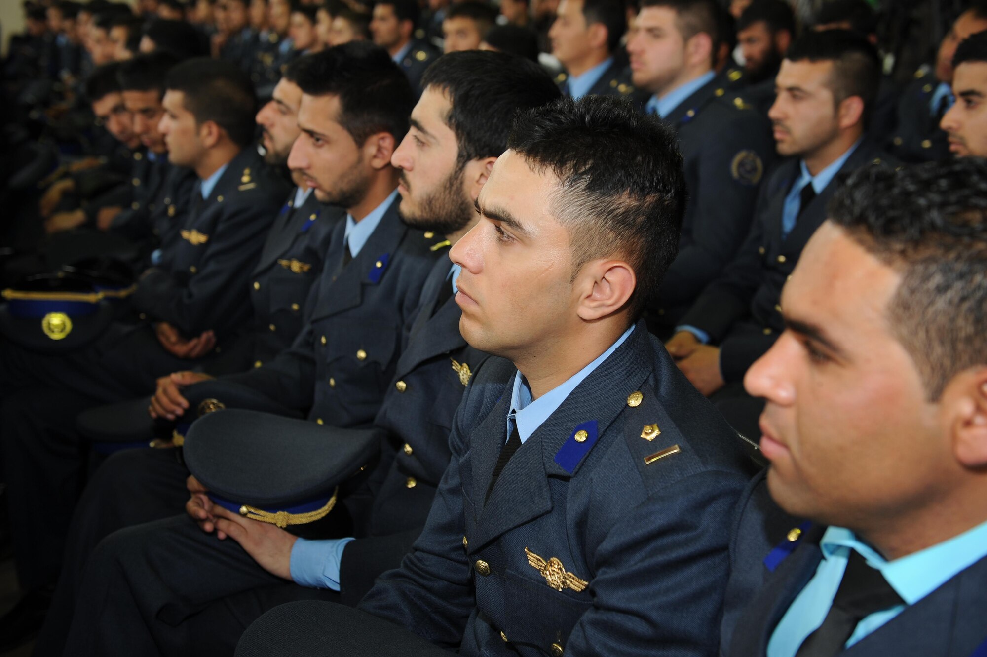 Soon to be graduates of the Afghan Air Force academy await to receive their diplomas during a ceremony, May 7, 2014. The ceremony marked the first graduation since the fall of the Taliban, adding 184 newly commissioned second lieutenants to the Afghan Air Force. (Official U.S. Air Force photo/Capt. Jeff M. Nagan)