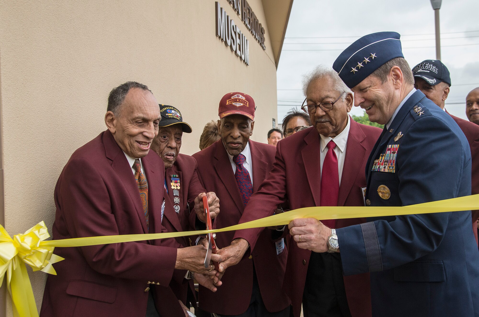 Tuskegee Airmen (from left) Eugene Derricotte, Thomas M. Ellis, Granville C. Coggs and James L. Bynum and the commander of Air Education and Training Command, Gen. Robin Rand, cut the ribbon May 4, 2015, at Joint Base San Antonio-Lackland’s Airman Heritage Museum. The unveiling ceremony honors the enlisted Tuskegee Airmen, a group of African-American military ground support Airmen who were part of the 332nd Fighter Group and the 477th Bombardment Group during World War II. (U.S. Air Force photo/Johnny Saldivar)