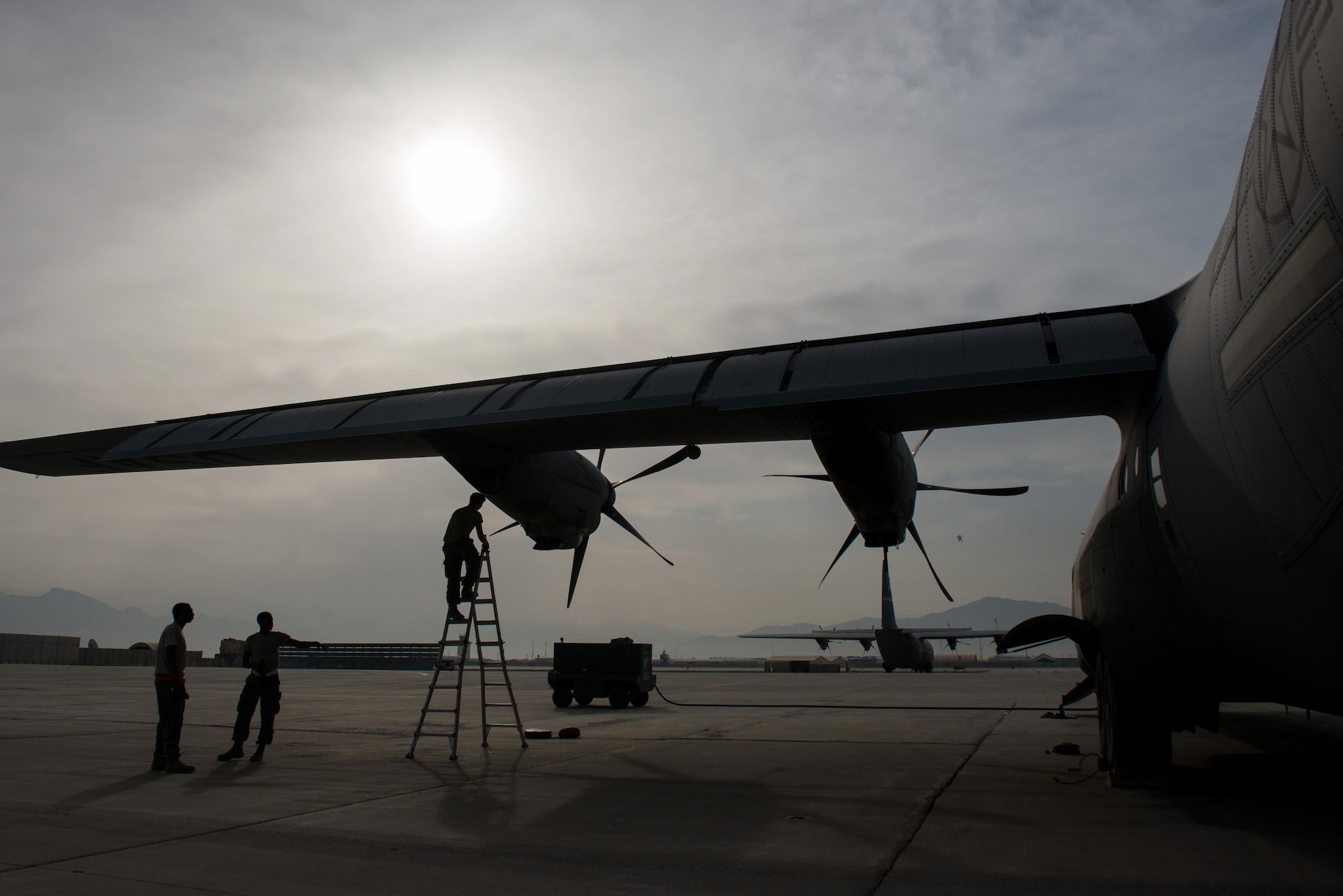 U.S. Airmen assigned to the 455th Expeditionary Aircraft Maintenance Squadron perform post flight checks on a C-130J Super Hercules aircraft on the flight line at Bagram Airfield, Afghanistan, May 5, 2015.  The 455th EAMXS ensure Super Hercules on Bagram are prepared for flight and return them to a mission-ready state once they land. (U.S. Air Force photo by Tech. Sgt. Joseph Swafford/Released) 