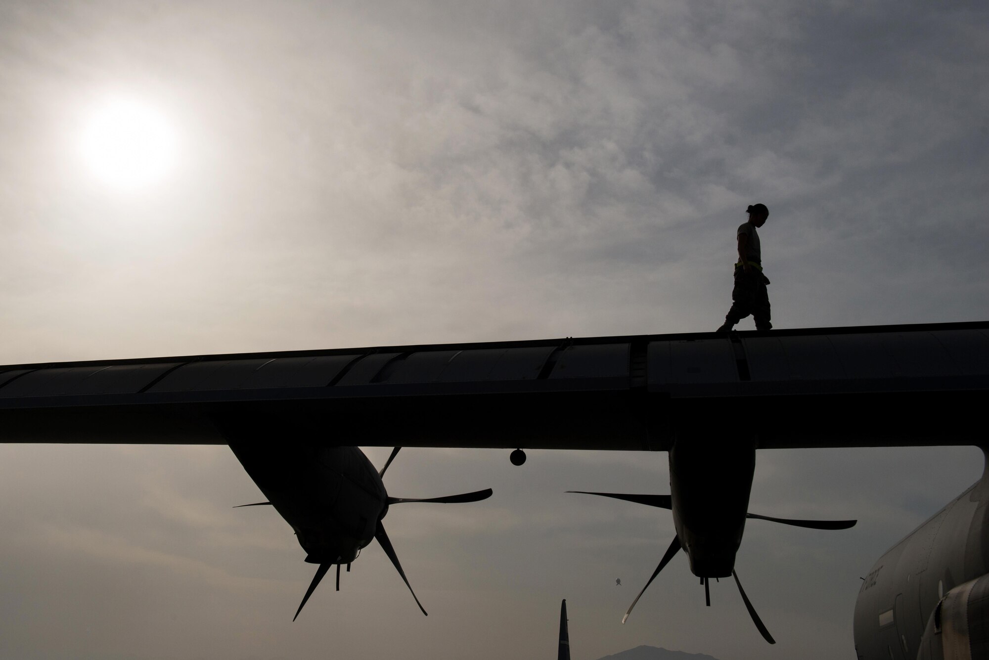 U.S. Air Force Senior Airman Mina Phouangphidok, assigned to the 455th Expeditionary Aircraft Maintenance Squadron, checks the wings on a C-130J Super Hercules aircraft during a post flight inspection on the flight line at Bagram Airfield, Afghanistan, May 5, 2015.  The 455th EAMXS ensure Super Hercules on Bagram are prepared for flight and return them to a mission-ready state once they land. (U.S. Air Force photo by Tech. Sgt. Joseph Swafford/Released)