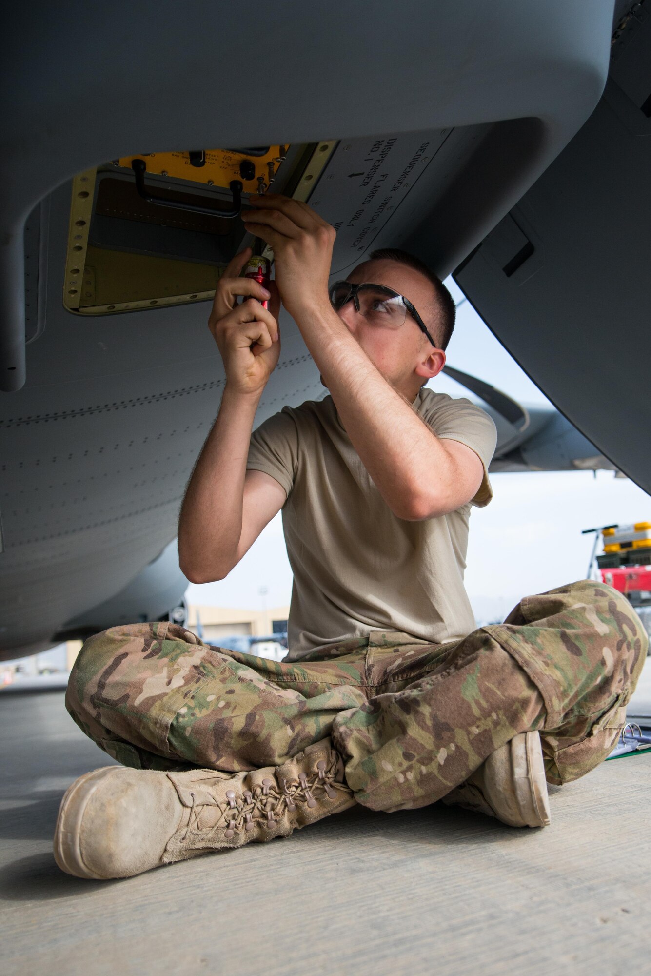 U.S. Air Force Airman Christopher Koepnick, assigned to the 455th Expeditionary Aircraft Maintenance Squadron, installs a countermeasure set for testing on a C-130J Super Hercules aircraft on the flight line at Bagram Airfield, Afghanistan, May 5, 2015.  The 455th EAMXS ensure Super Hercules on Bagram are prepared for flight and return them to a mission-ready state once they land. (U.S. Air Force photo by Tech. Sgt. Joseph Swafford/Released)