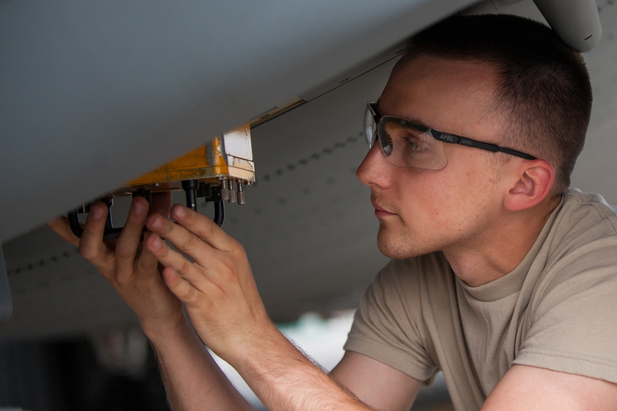 U.S. Air Force Airman Christopher Koepnick, assigned to the 455th Expeditionary Aircraft Maintenance Squadron, installs a countermeasure set for testing on a C-130J Super Hercules aircraft on the flight line at Bagram Airfield, Afghanistan, May 5, 2015.  The 455th EAMXS ensure Super Hercules on Bagram are prepared for flight and return them to a mission-ready state once they land. (U.S. Air Force photo by Tech. Sgt. Joseph Swafford/Released)