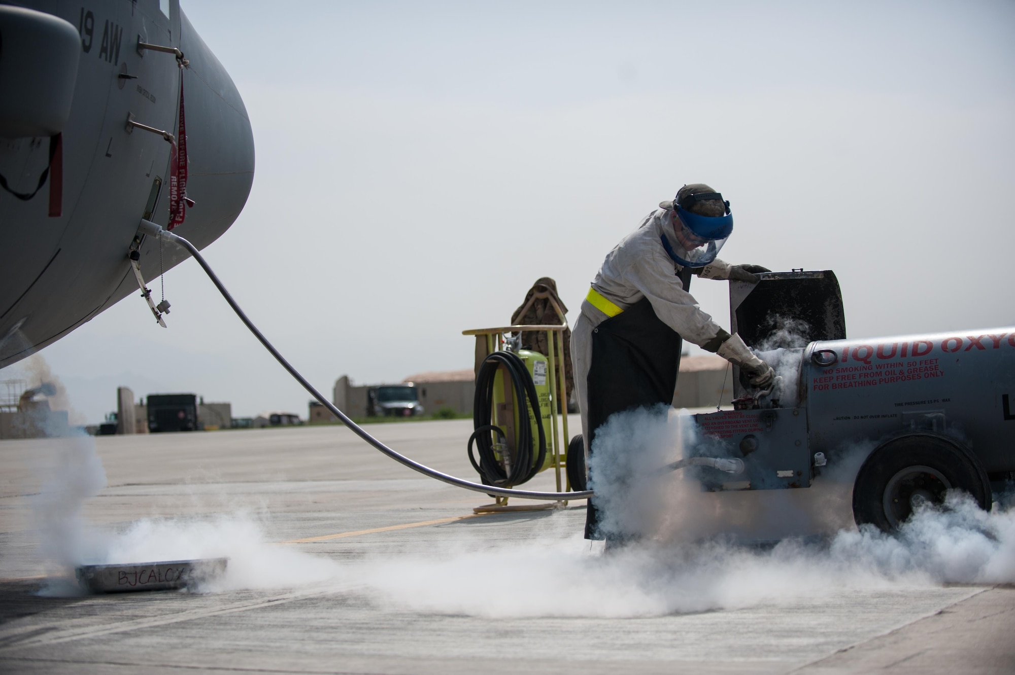 U.S. Air Force Airman 1st Class Ryan Munchel, assigned to the 455th Expeditionary Aircraft Maintenance Squadron, transfers liquid oxygen to an LOX reservoir in a C-130J Super Hercules aircraft on the flight line at Bagram Airfield, Afghanistan, May 5, 2015.  The 455th EAMXS ensure Super Hercules on Bagram are prepared for flight and return them to a mission-ready state once they land. (U.S. Air Force photo by Tech. Sgt. Joseph Swafford/Released)