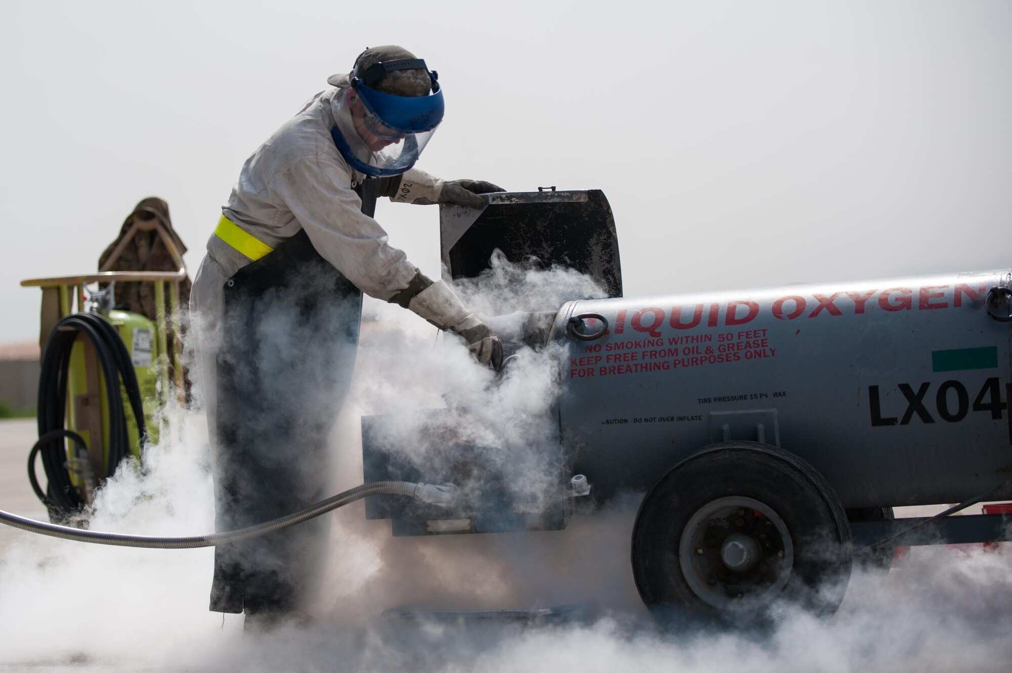 U.S. Air Force Airman 1st Class Ryan Munchel, assigned to the 455th Expeditionary Aircraft Maintenance Squadron, transfers liquid oxygen to an LOX reservoir in a C-130J Super Hercules aircraft on the flight line at Bagram Airfield, Afghanistan, May 5, 2015.  The 455th EAMXS ensure Super Hercules on Bagram are prepared for flight and return them to a mission-ready state once they land. (U.S. Air Force photo by Tech. Sgt. Joseph Swafford/Released)
