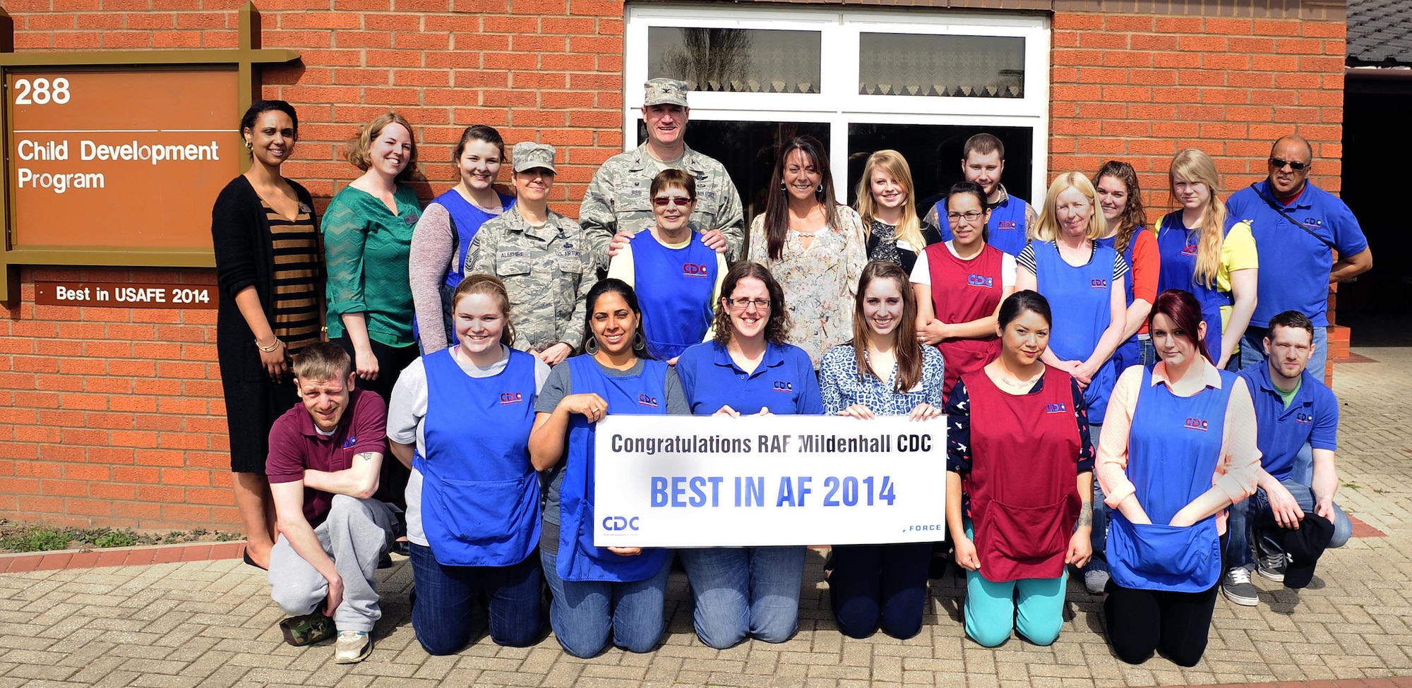 Members of the 100th Force Support Squadron Child Development Program gather for a group photo with Col. Kenneth T. Bibb, Jr., the 100th Air Refueling Wing commander and Chief Master Sgt. Kathryn Aleshire, the 100 ARW acting command chief, April 13, 2015, at the child development center on Royal Air Force Mildenhall, England. The CDC team was recently chosen as the Air Force’s best Child Development Program of the Year 2014. (U.S. Air Force photo/Staff Sgt. Krystie Martinez) 